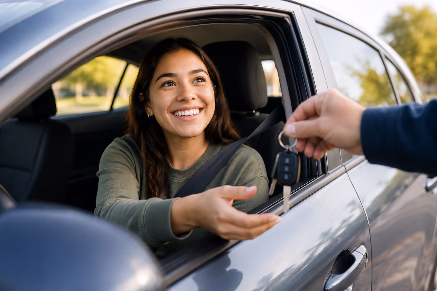 Student in car being handed keys