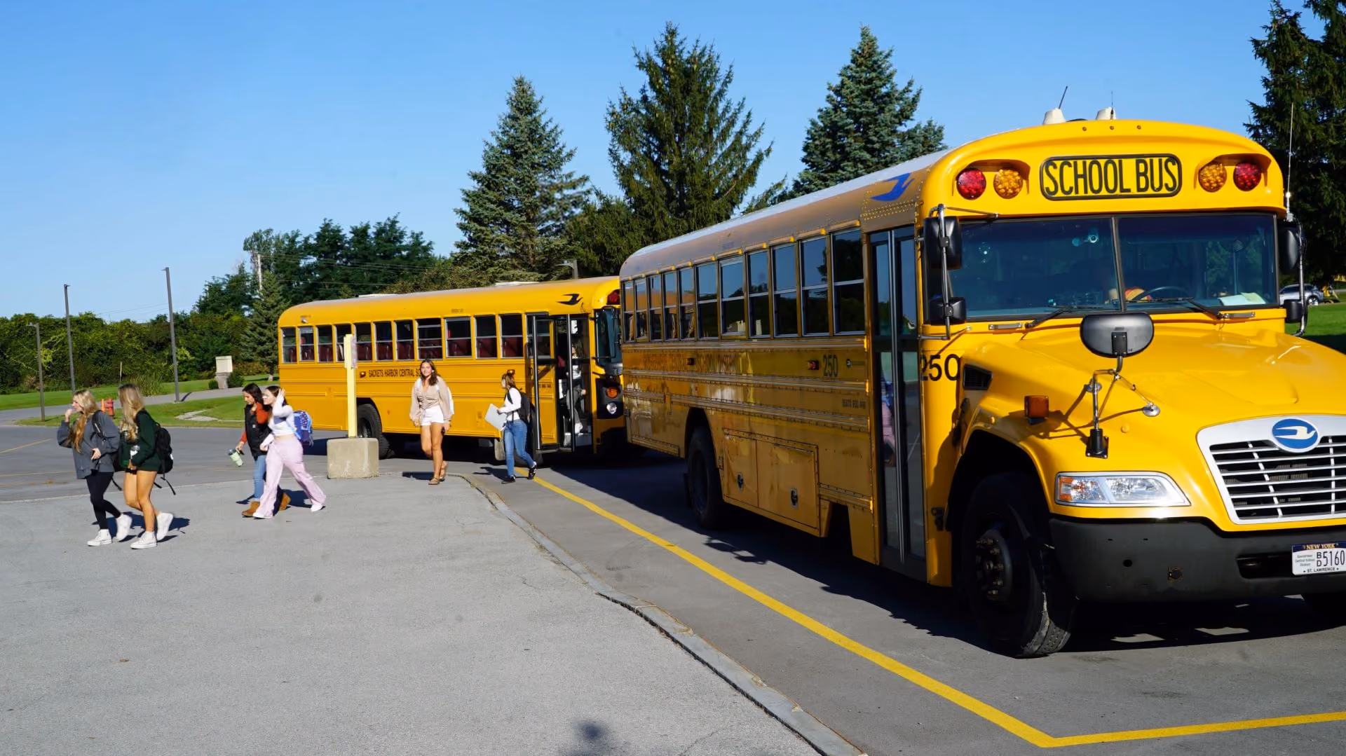 Students walking away from bus and on the way to school. 