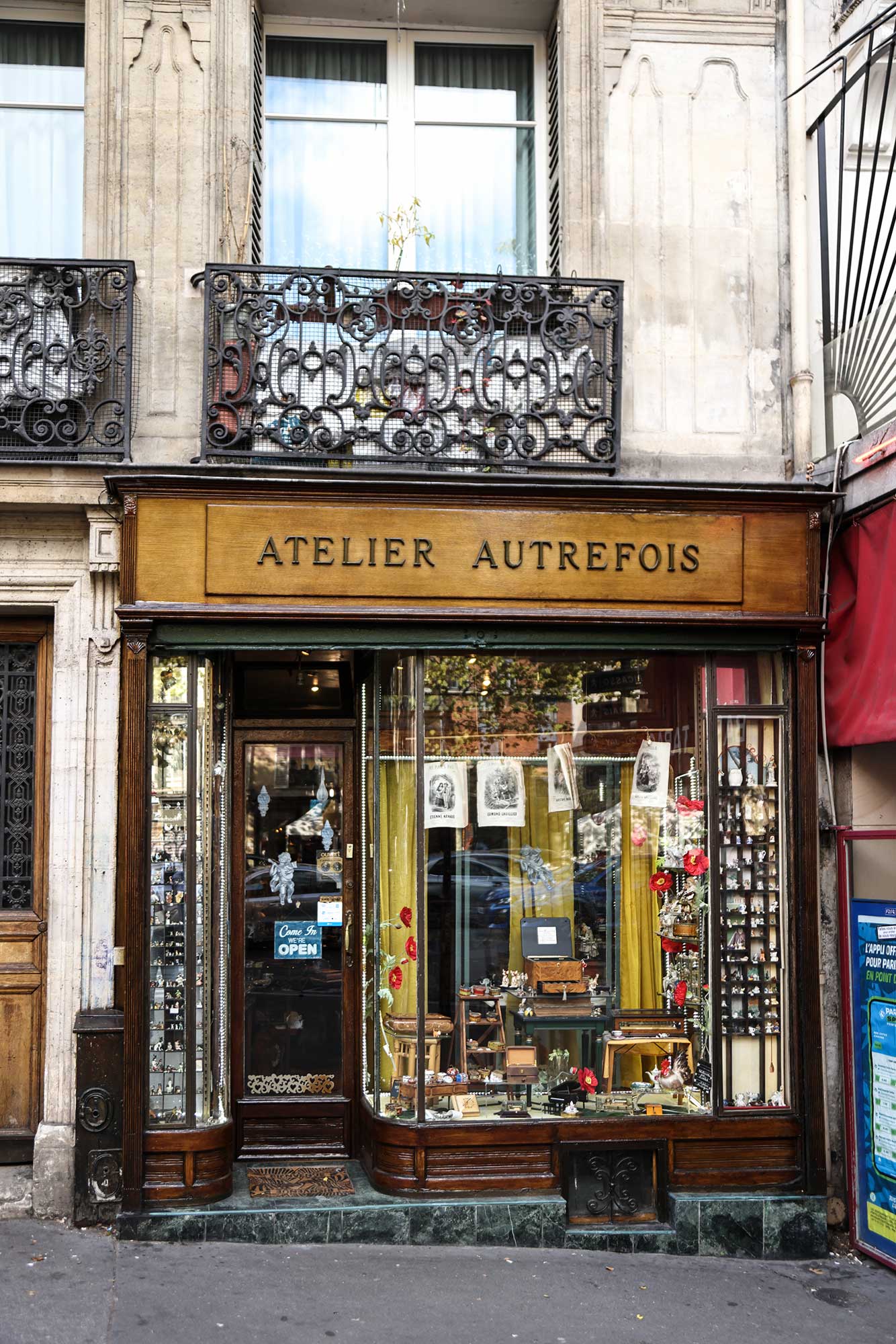 Tucked along a charming Parisian street, Atelier Autrefois invites you to step into another era—its vintage window displays and carefully curated curiosities capturing the quiet romance of old-world Paris.