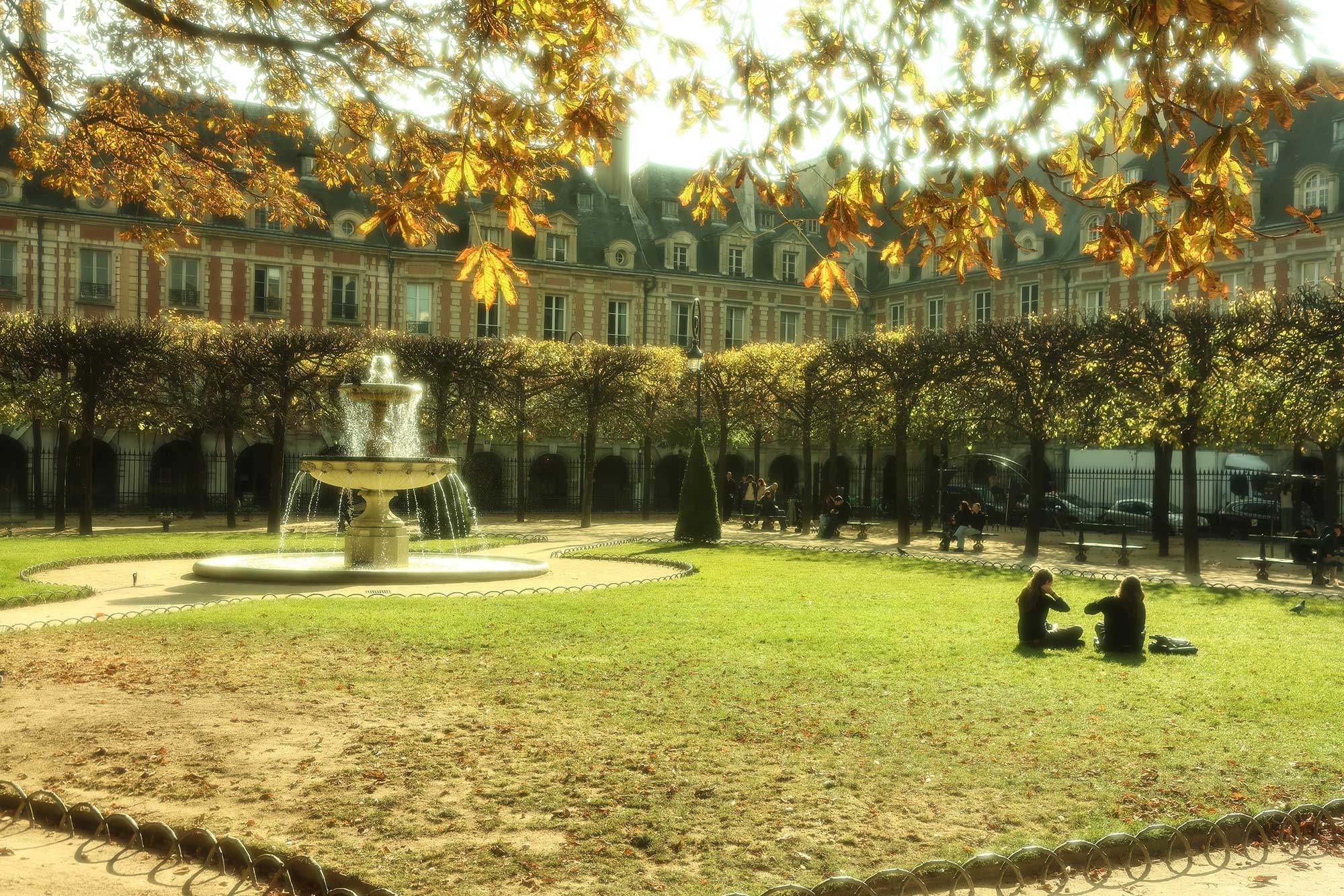Relaxing in the heart of Paris at Place des Vosges, where history and tranquility meet.