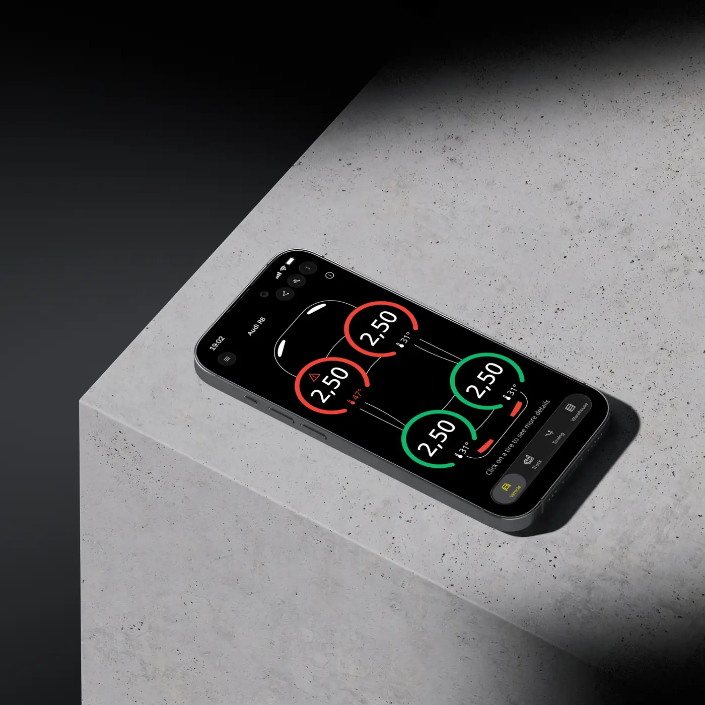 Téléphone posé montrant l'écran de pression des pneus.