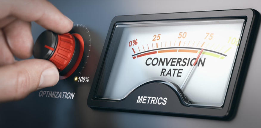 Hand turning an optimization dial next to a gauge measuring conversion rate metrics, symbolizing CRO performance improvement