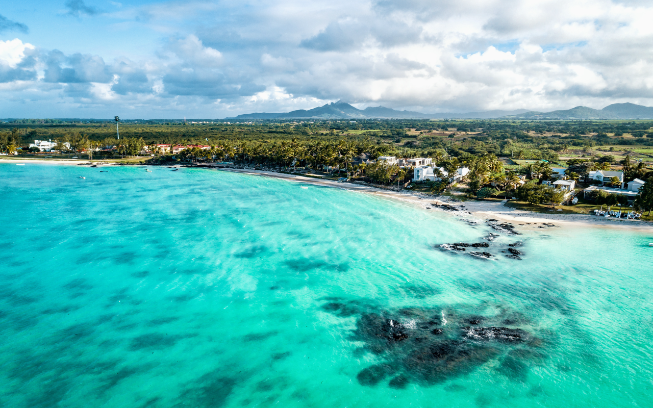 Aerial drone view at luxury resorts and coastline at Belle Mare beach on island Mauritius