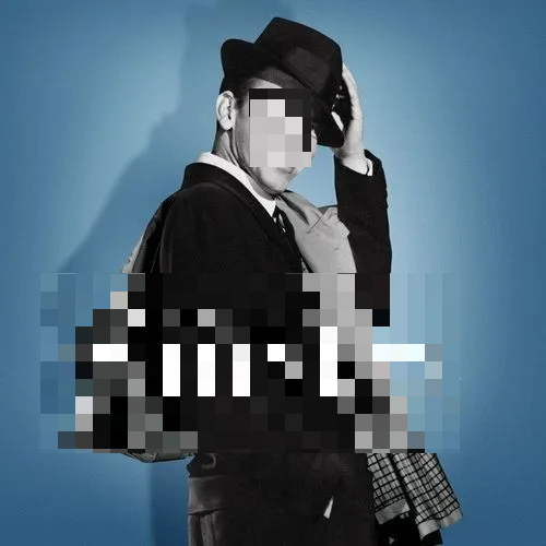 A man in a suit and tie is smiling.