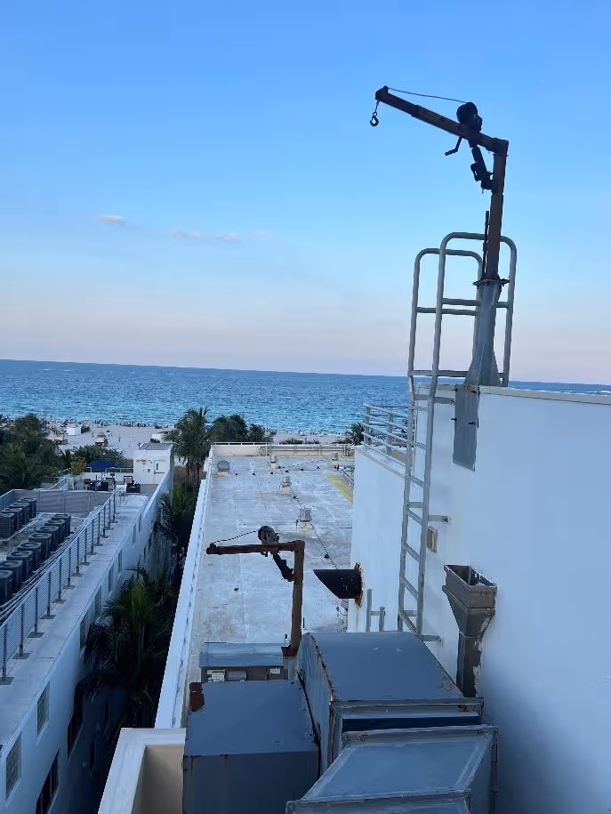 A crane on top of a buildingDescription automatically generated