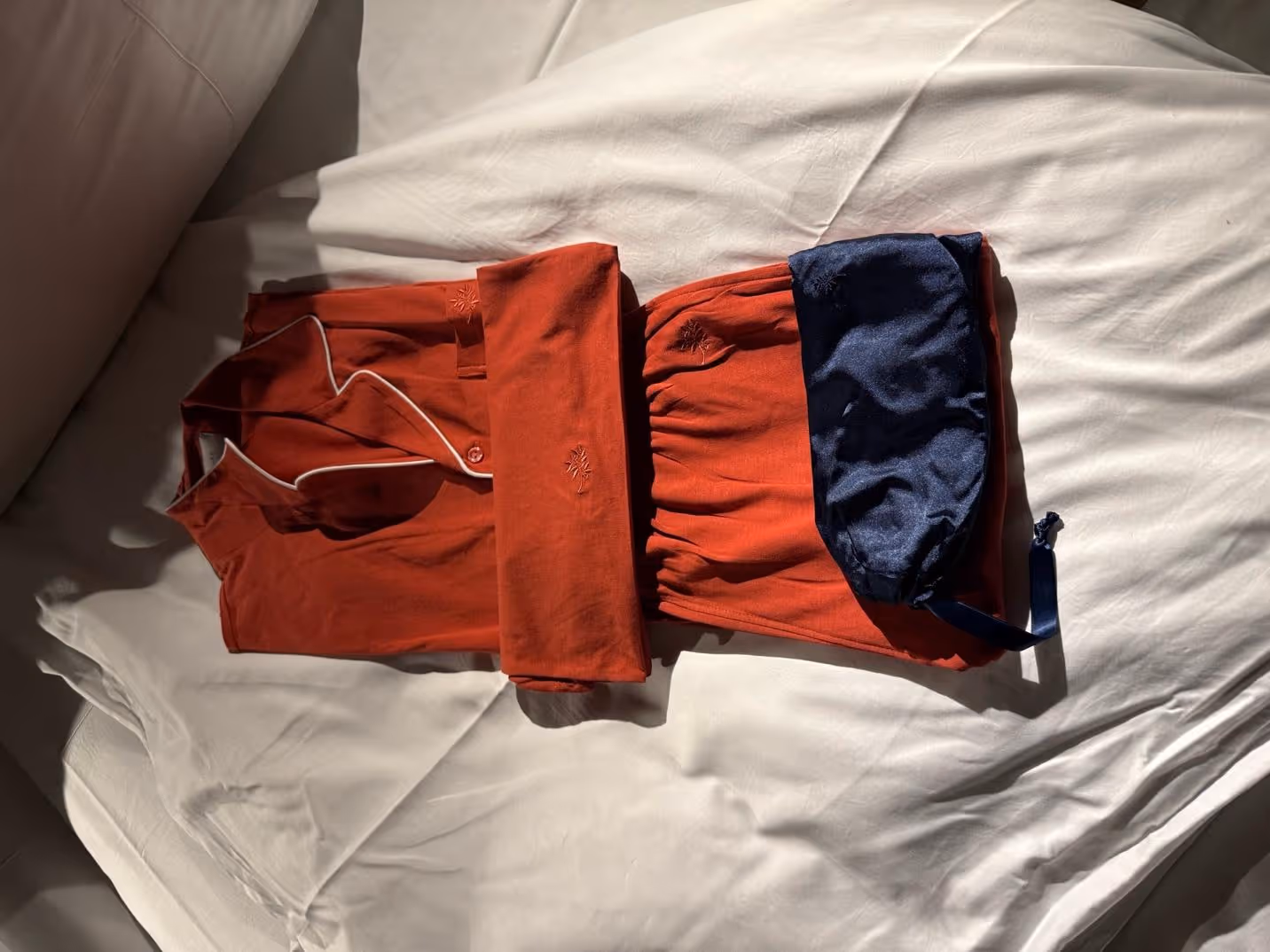 A red and blue outfit on a white surfaceDescription automatically generated