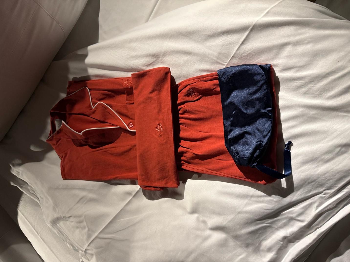A red and blue outfit on a white surfaceDescription automatically generated