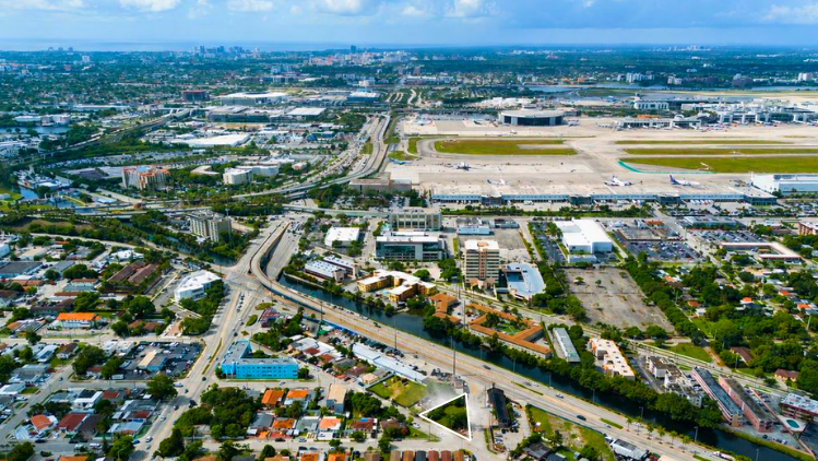 Aerial view of the 699 E Okeechobee Rd site outlined in white, with Miami International Airport in the background