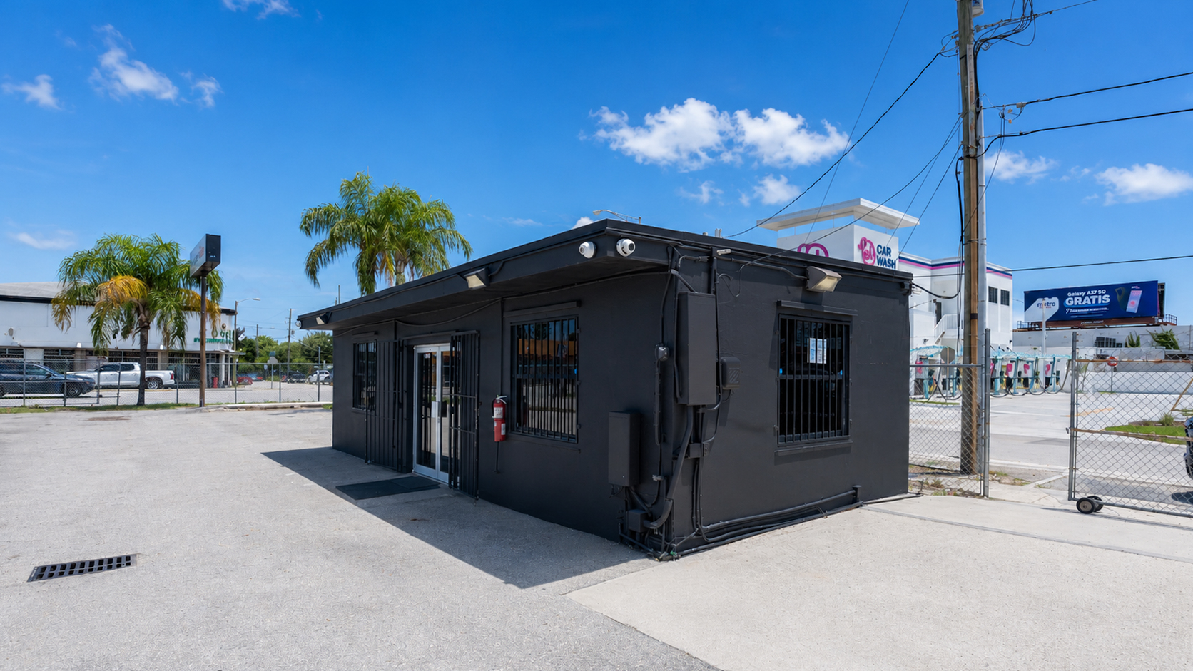 Corner view of the office building on the paved lot at 3100 NW 27th Ave, Miami