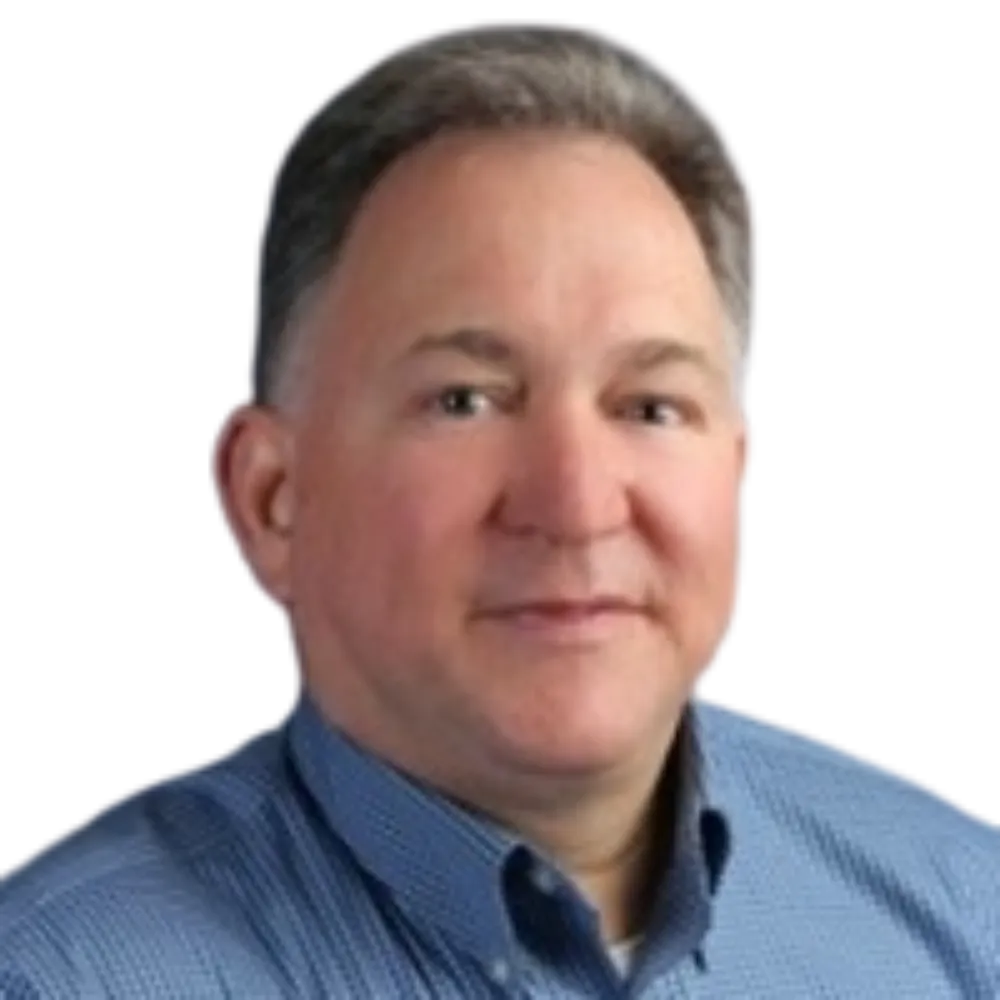 Headshot of a male in a dark blue and light blue checked dress shirt. 