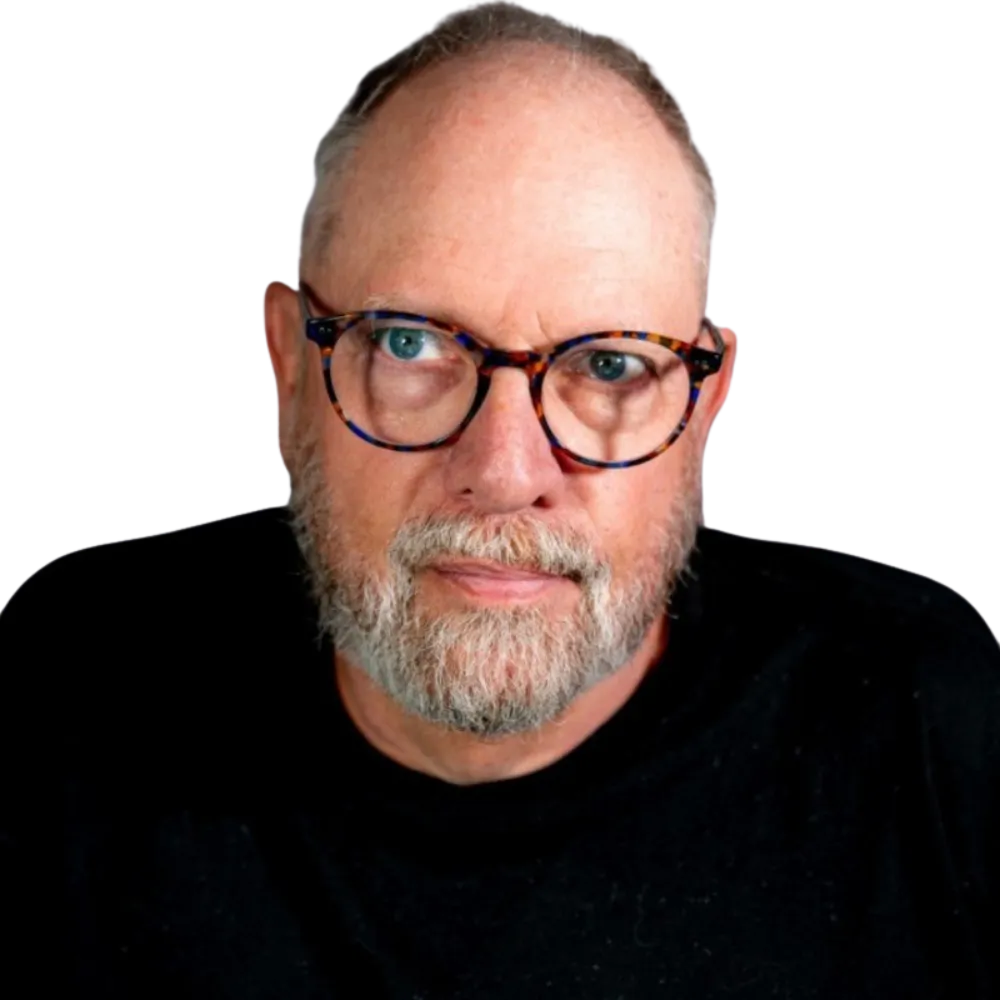 Headshot of a male with glasses and a beard in black shirt. 