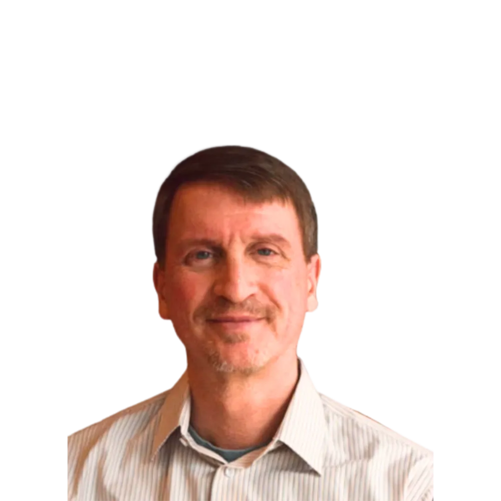 Headshot of a man with a mustache in a white colored shirt. 