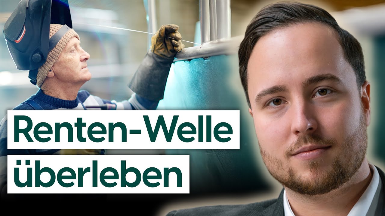 Älterer Facharbeiter übergibt Werkzeug an jüngeren Kollegen in einer Produktionshalle