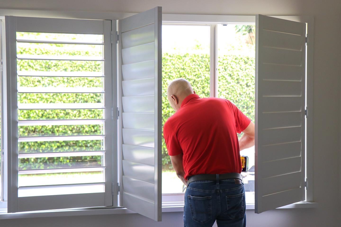RS Shutter Manufacturing installer installing custom plantation shutters for a dealer project in South Florida
