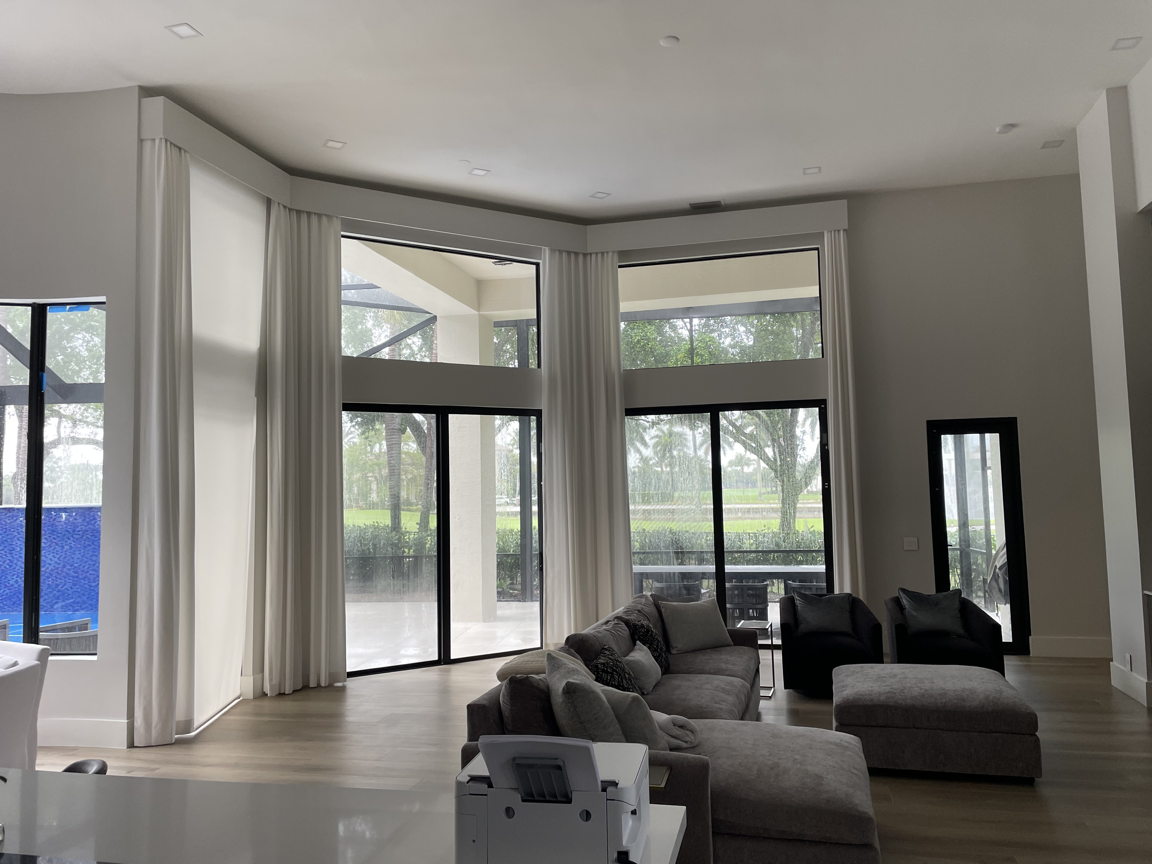 Custom poly cornice by RS Shutter Manufacturing installed above layered shades and drapes in a South Florida home