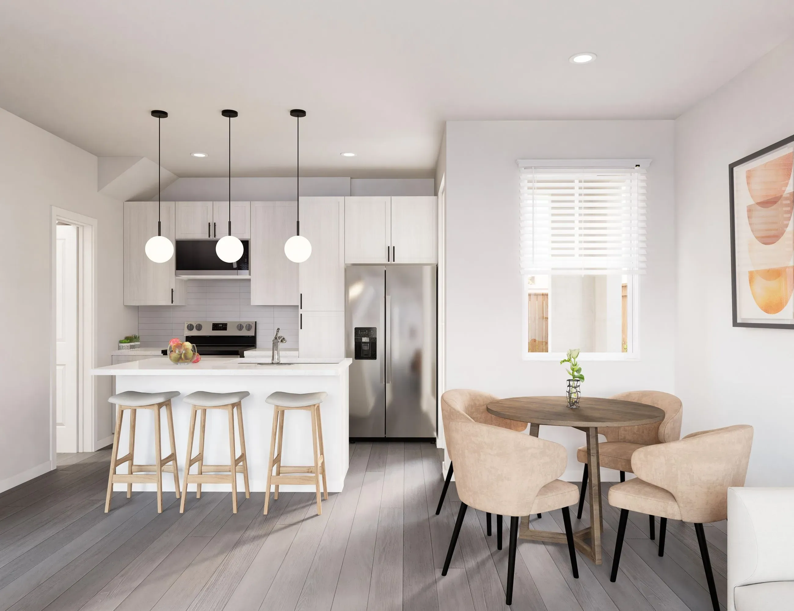 Modern kitchen with a light-toned island and a small dining table for four, in a home at The Eleanor Daytona Beach in Daytona Beach, Florida.