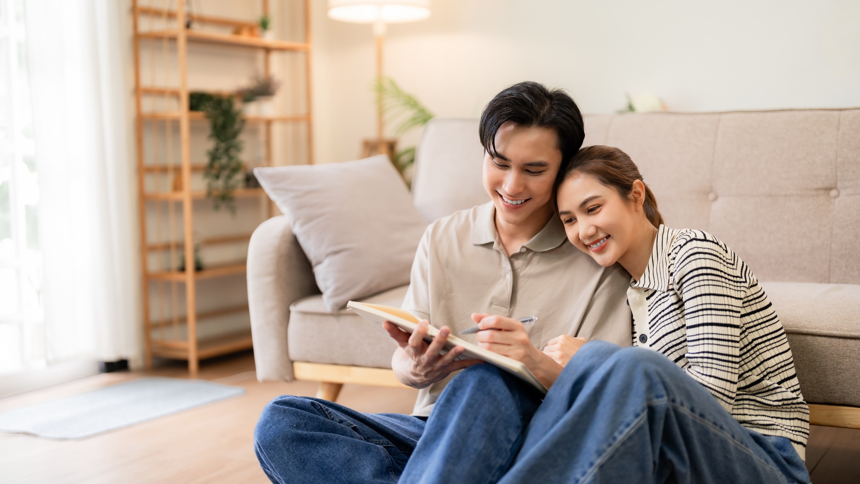 Residents relaxing in a sun-drenched living room at The Eleanor Daytona Beach, highlighting the community's modern apartment interiors and coastal lifestyle in Daytona Beach.