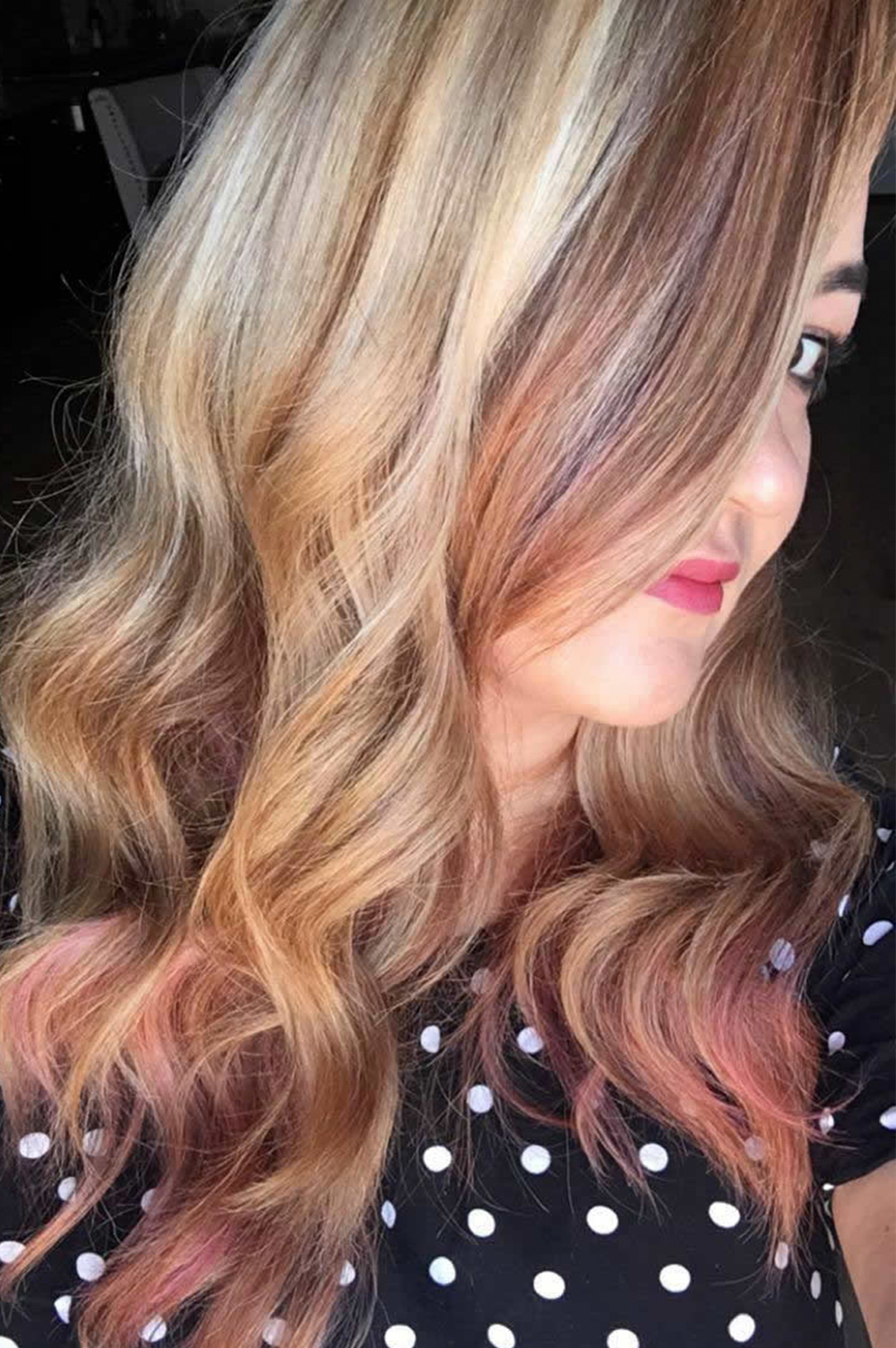 Wavy blonde and pink hair with soft curls and highlights