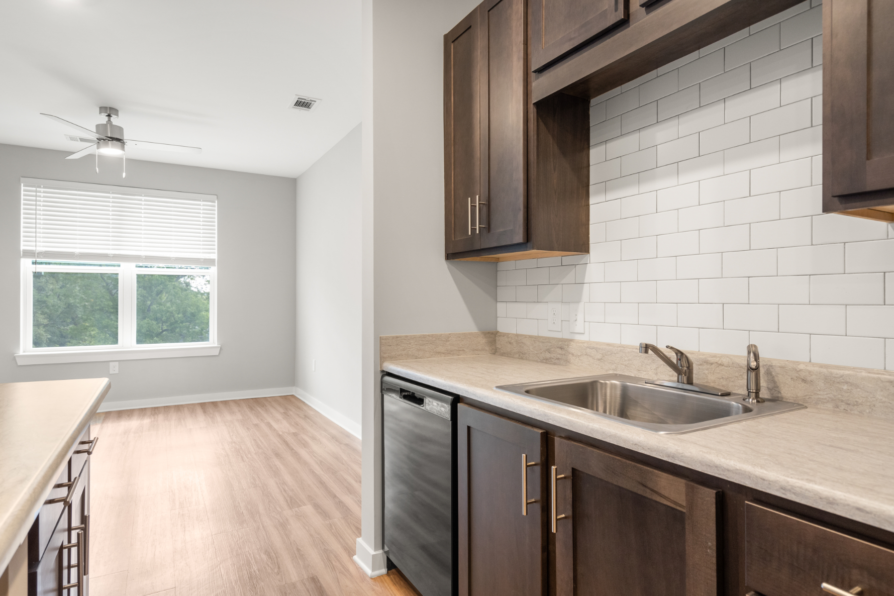 Kitchen with island, brown cabinets and black appliances
