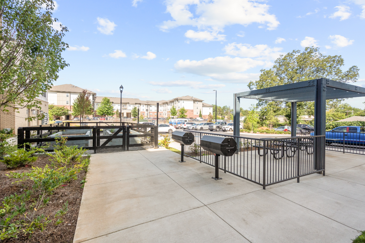 BBQ Area with Grills and picnic table and view of garden