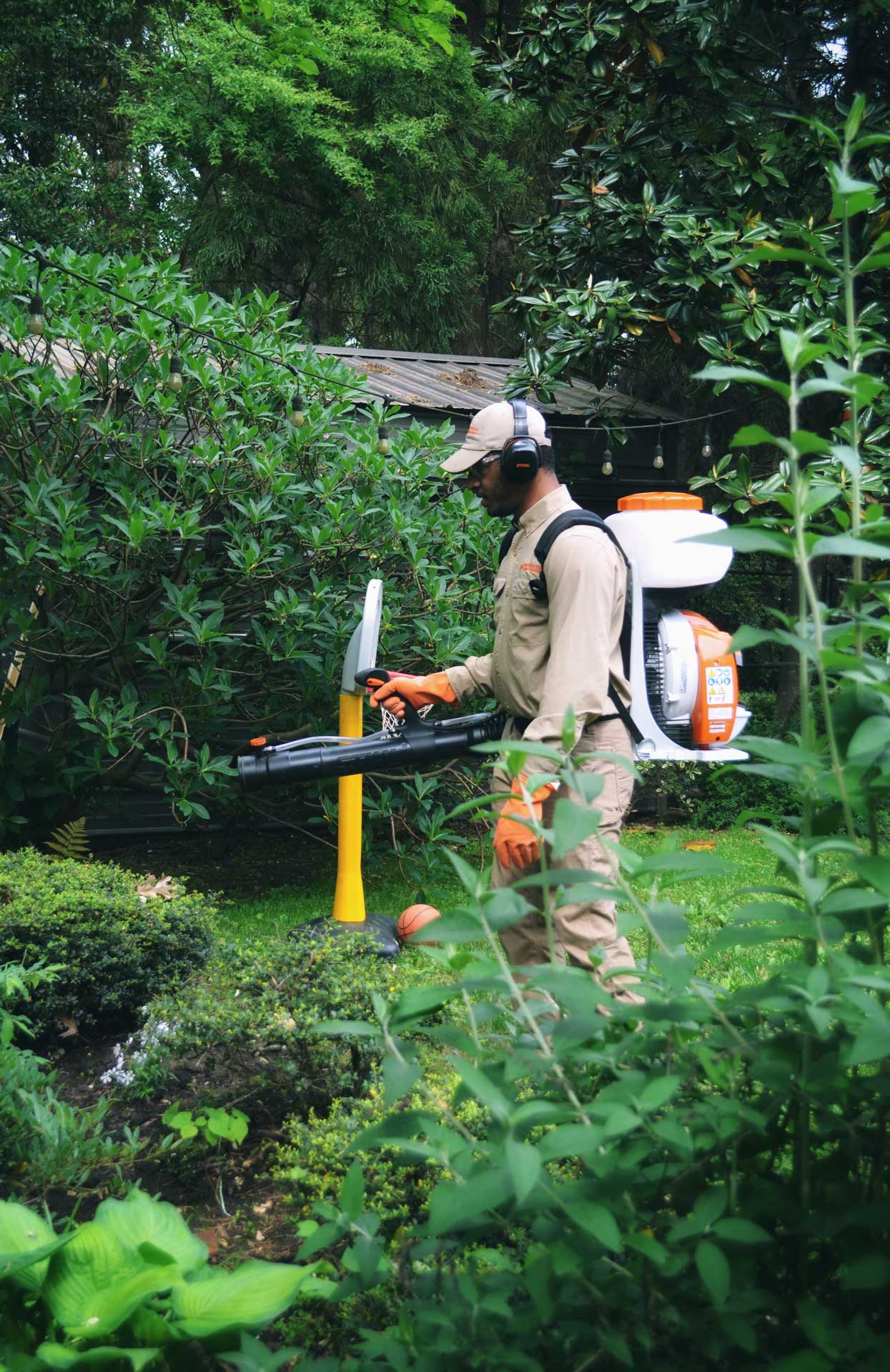 A Backyard Care team member treats for mosquitoes