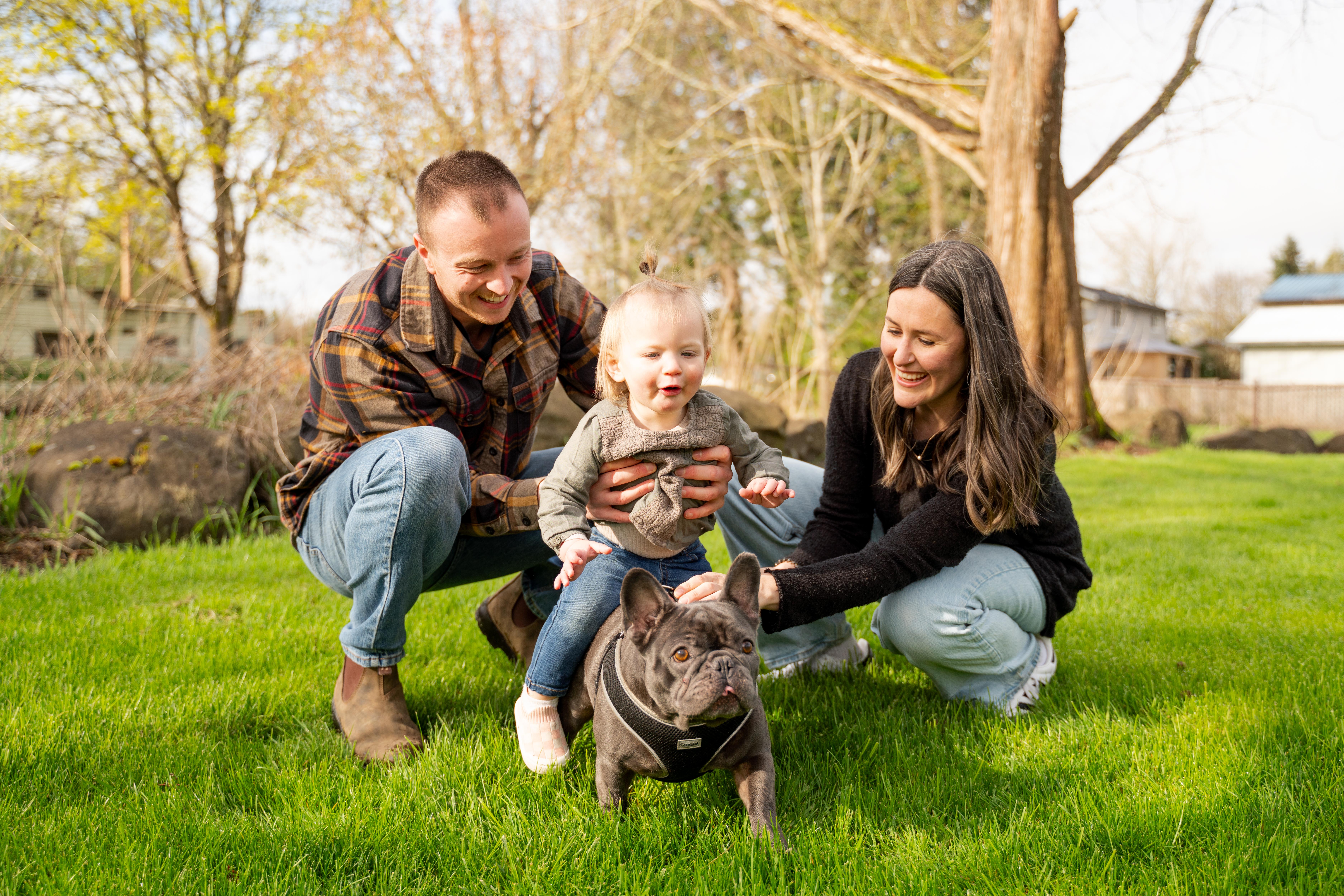Cute family playing with their dog, Layla.