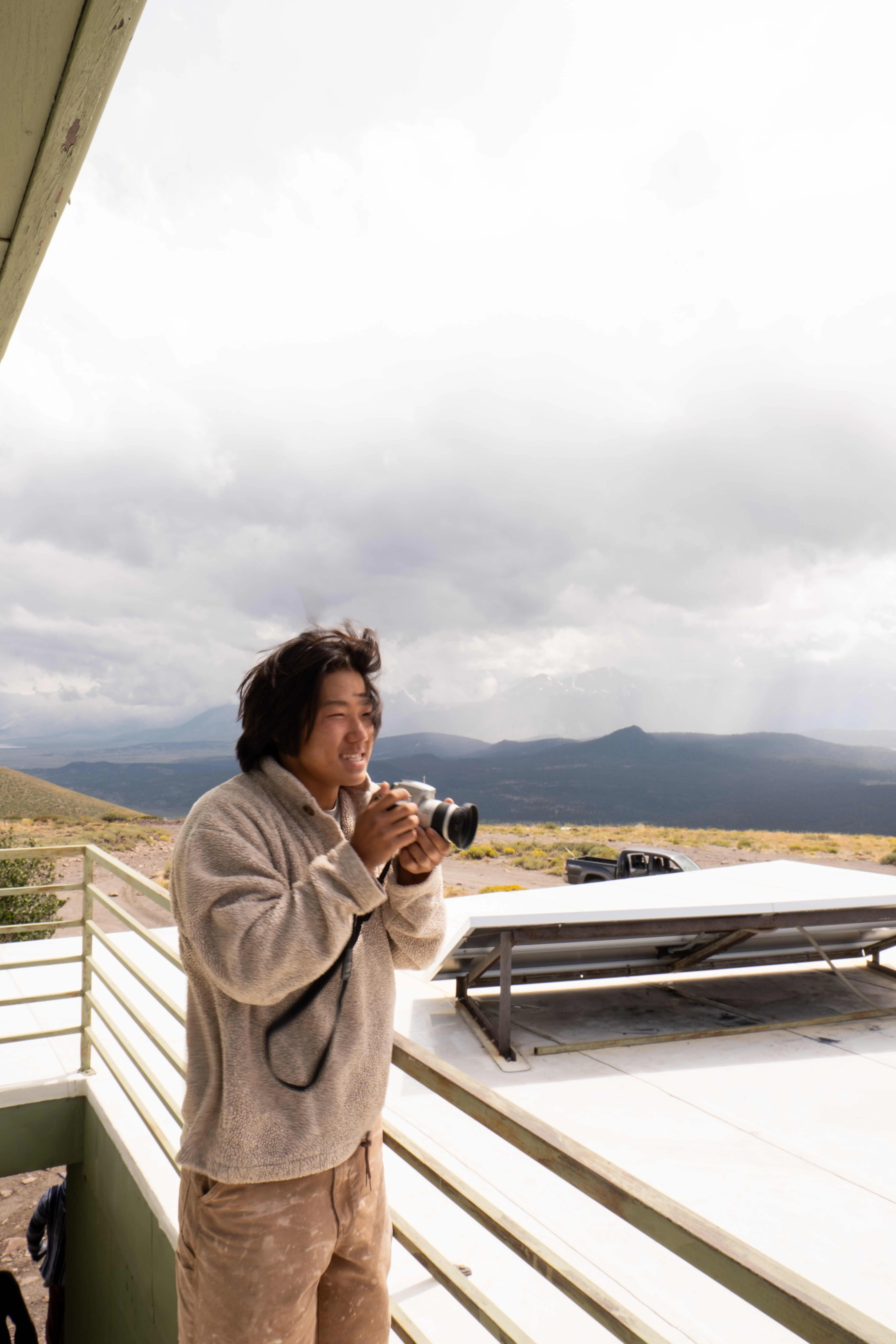 Outdoor lifestyle portrait of a photographer capturing images in natural light by San Diego lifestyle photographer Kanyon Studio