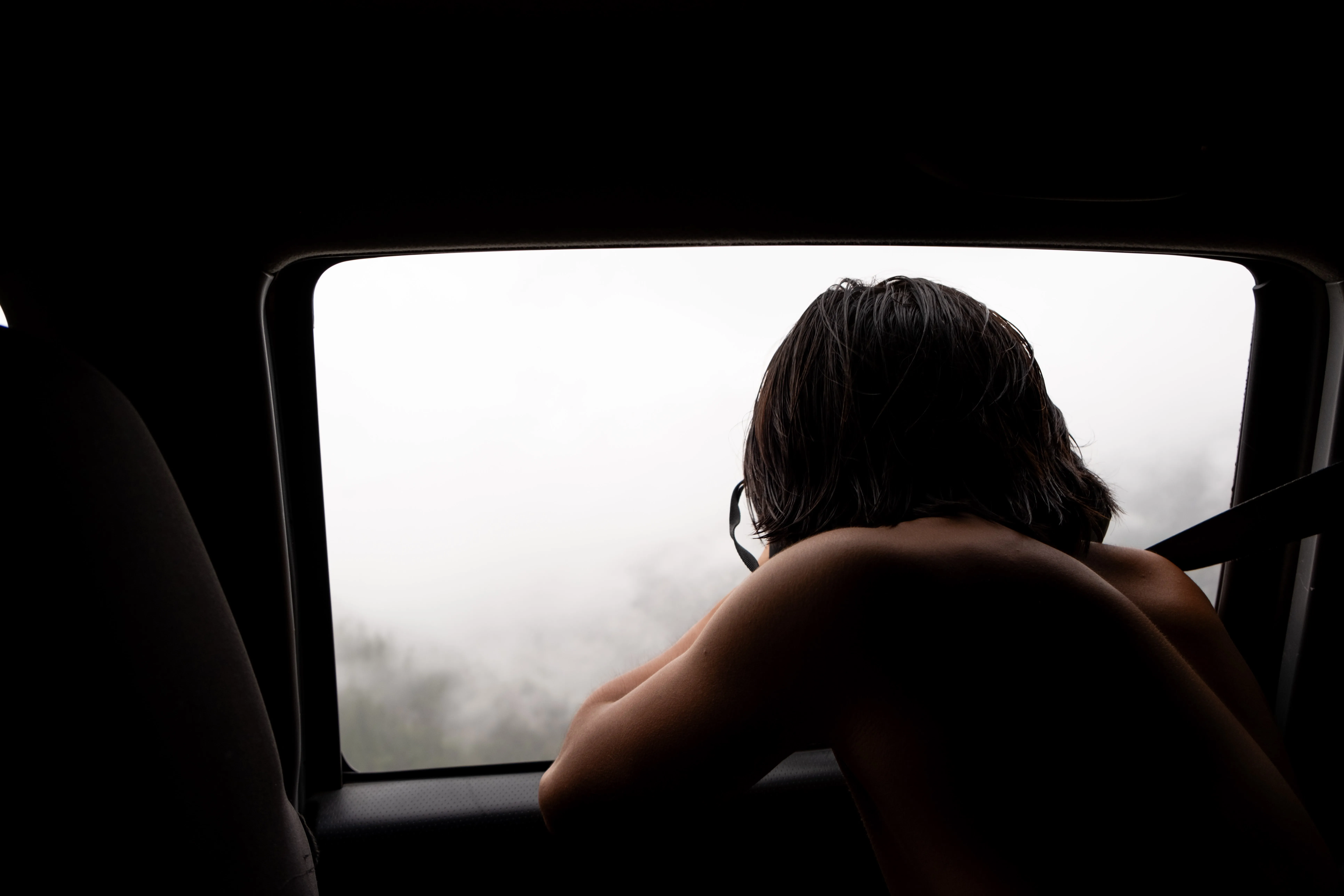 Lifestyle portrait photography of a person leaning out of a classic car window by San Diego photographer Kanyon Studio