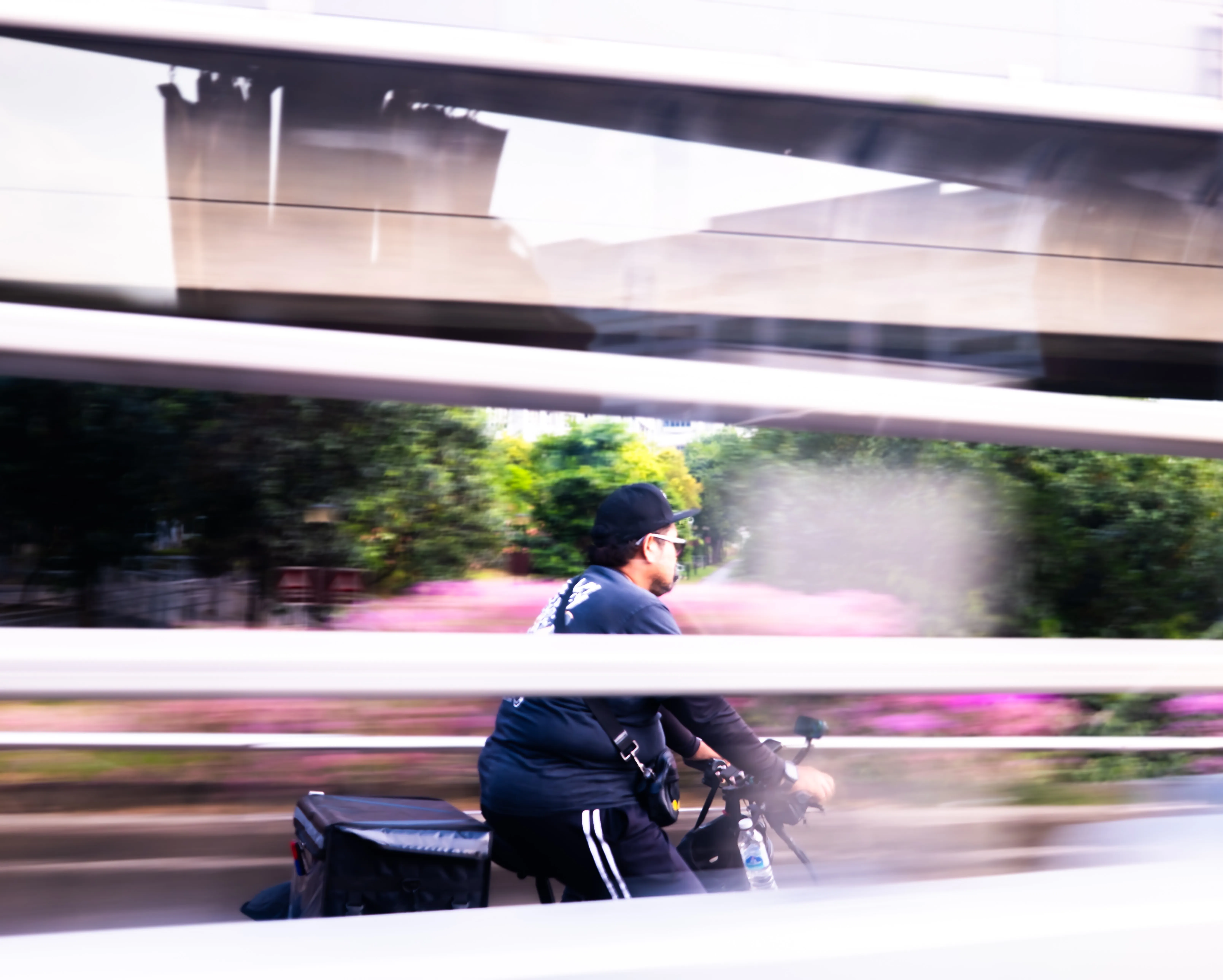Motion-blur lifestyle portrait photography of a biker on a city street by travel and lifestyle photographer Kanyon Studio