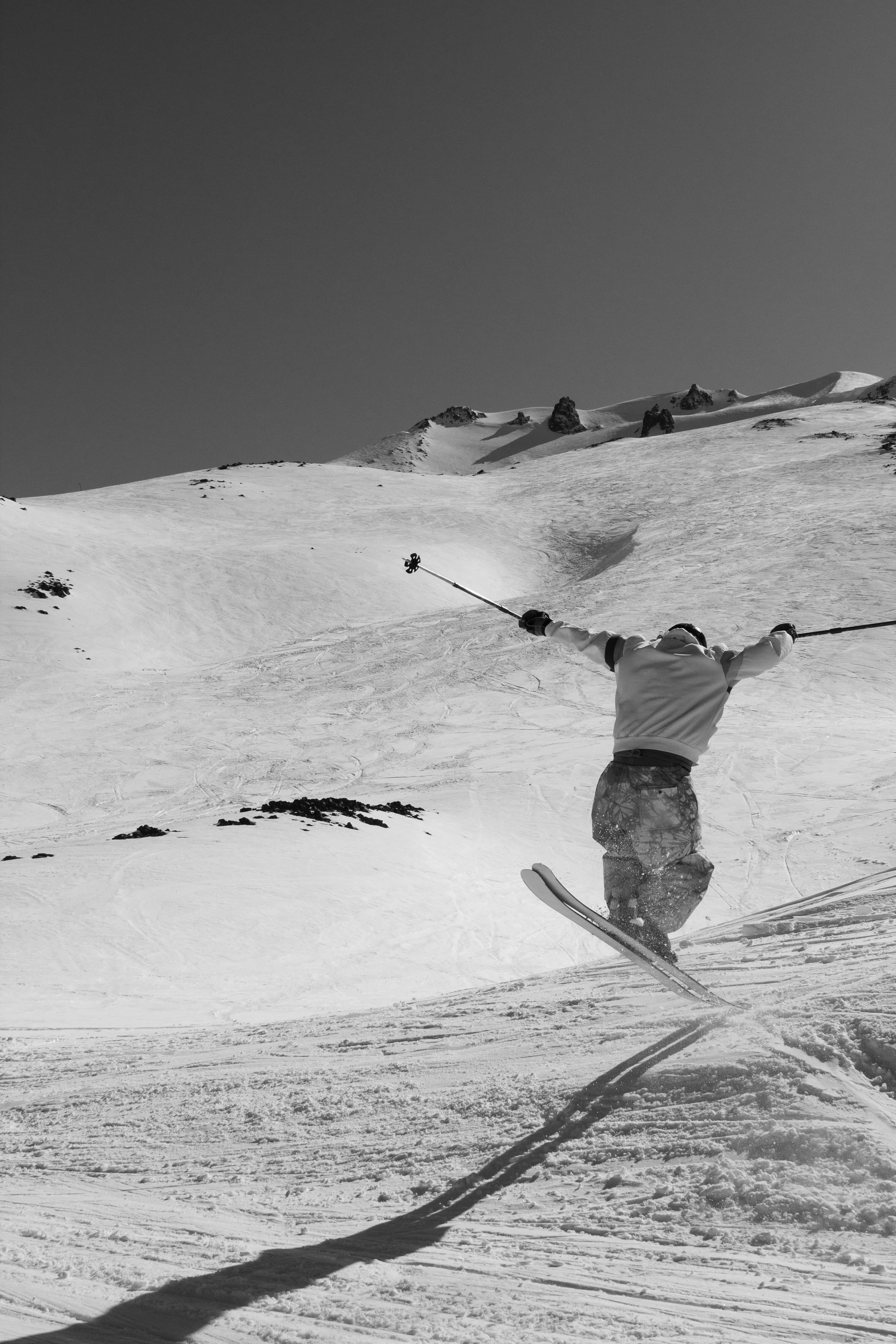 Black and white skiing action lifestyle photography on a mountain slope by San Diego adventure photographer Kanyon Studio