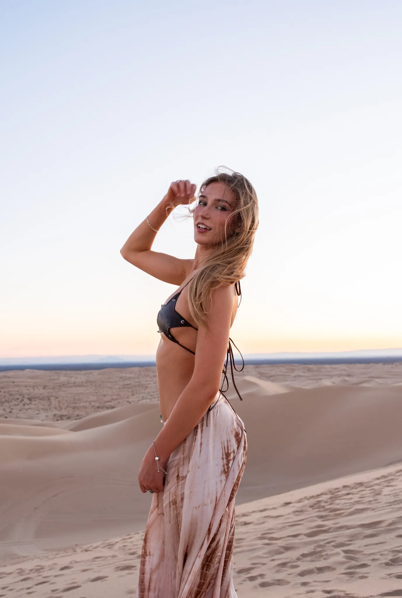 Evening sand dunes lifestyle portrait of a model styled for social content by San Diego lifestyle photographer Kanyon Studio