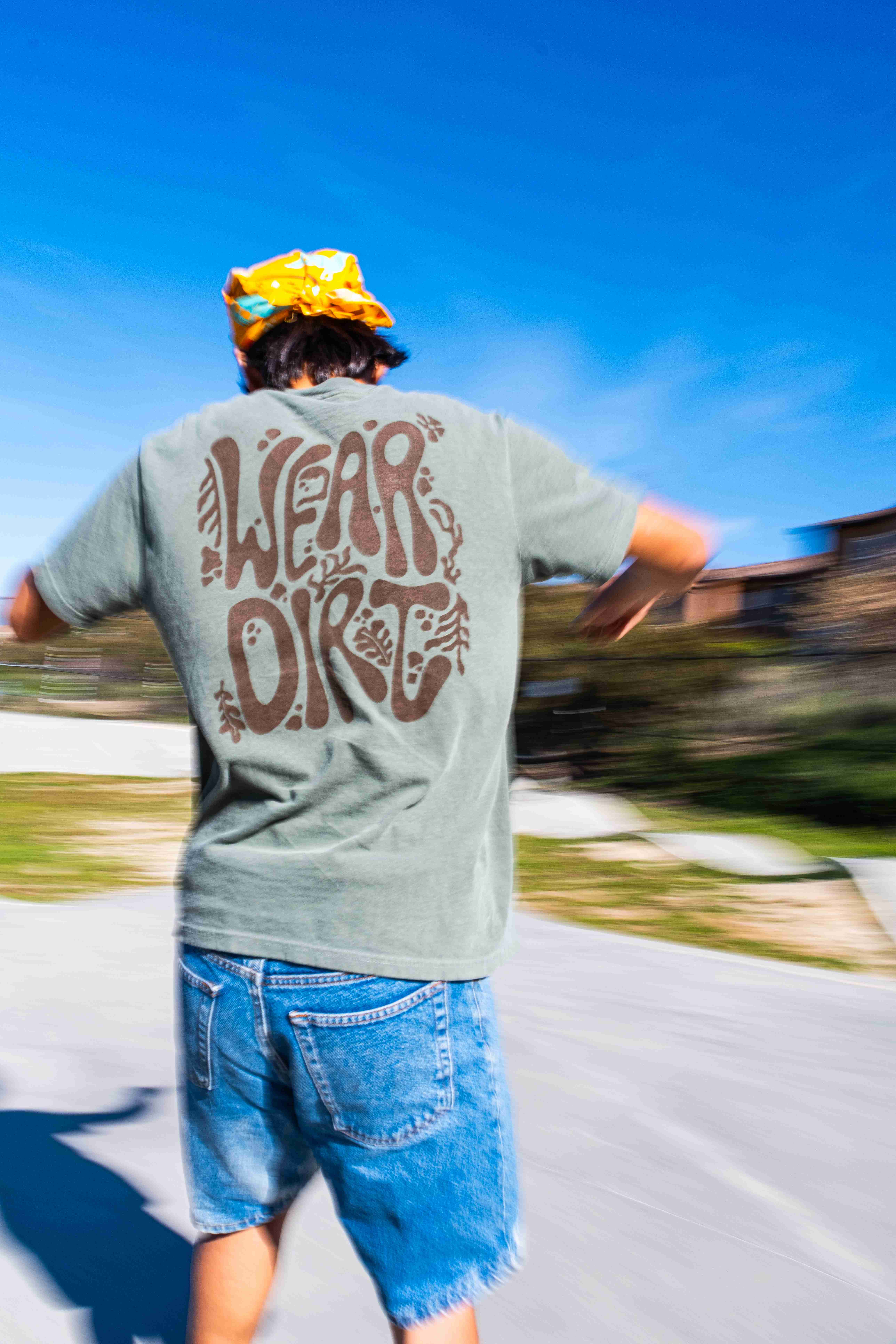 Lifestyle product image highlighting Wear Dirt apparel in outdoor setting for brand marketing.