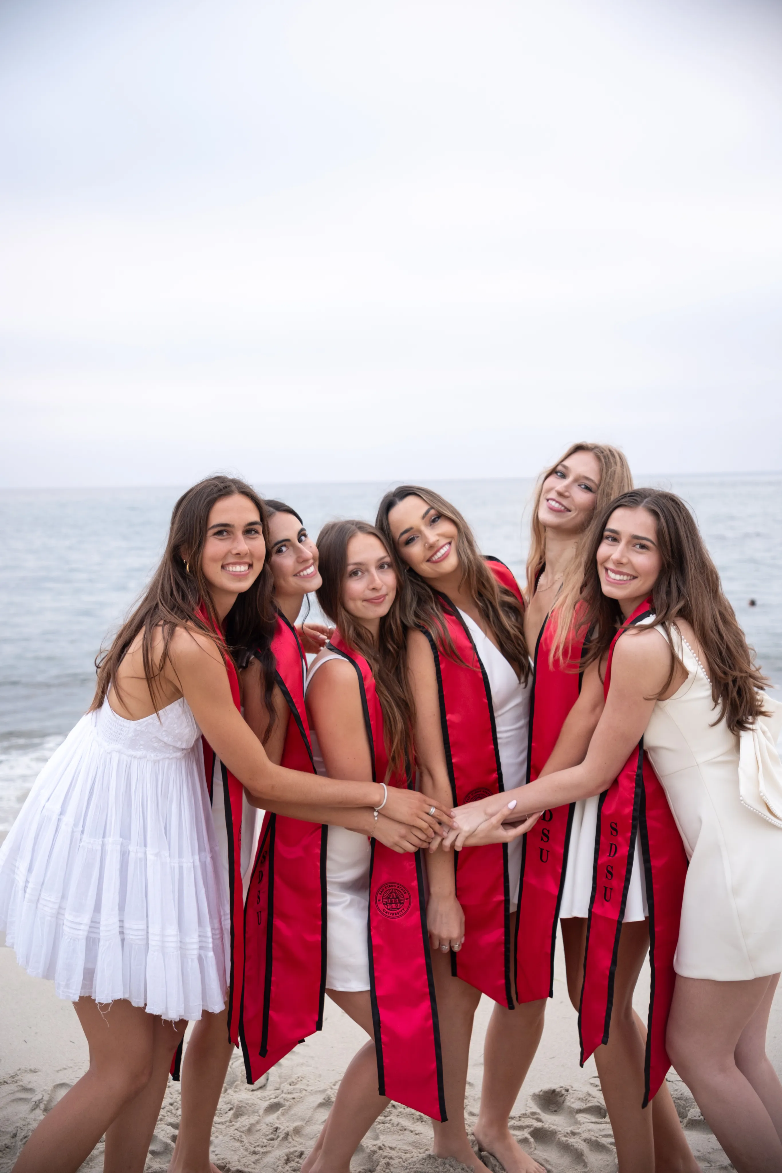 Senior in graduation regalia photographed in San Diego