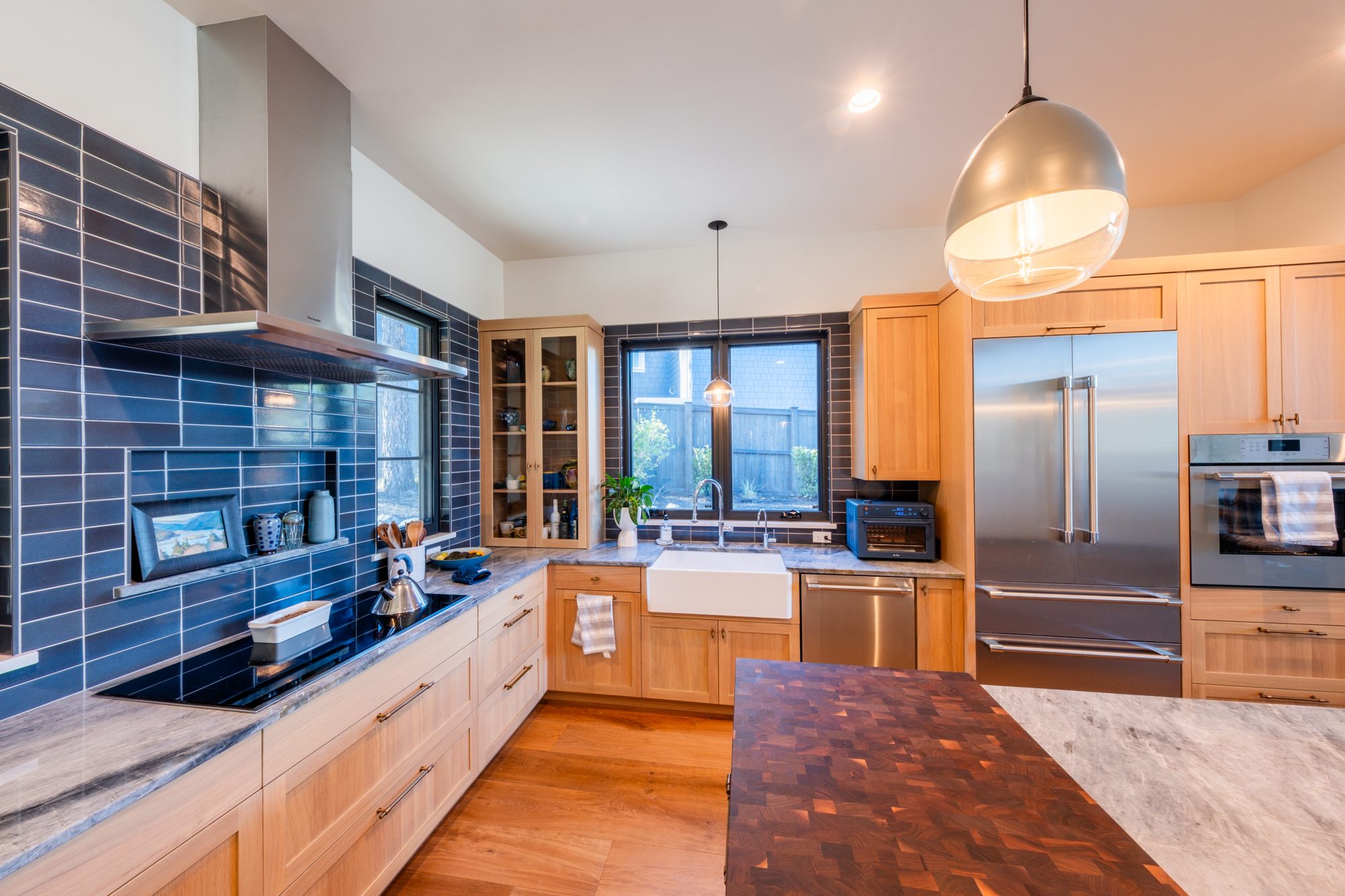 Kitchen detail with blue tile backsplash and cooktop