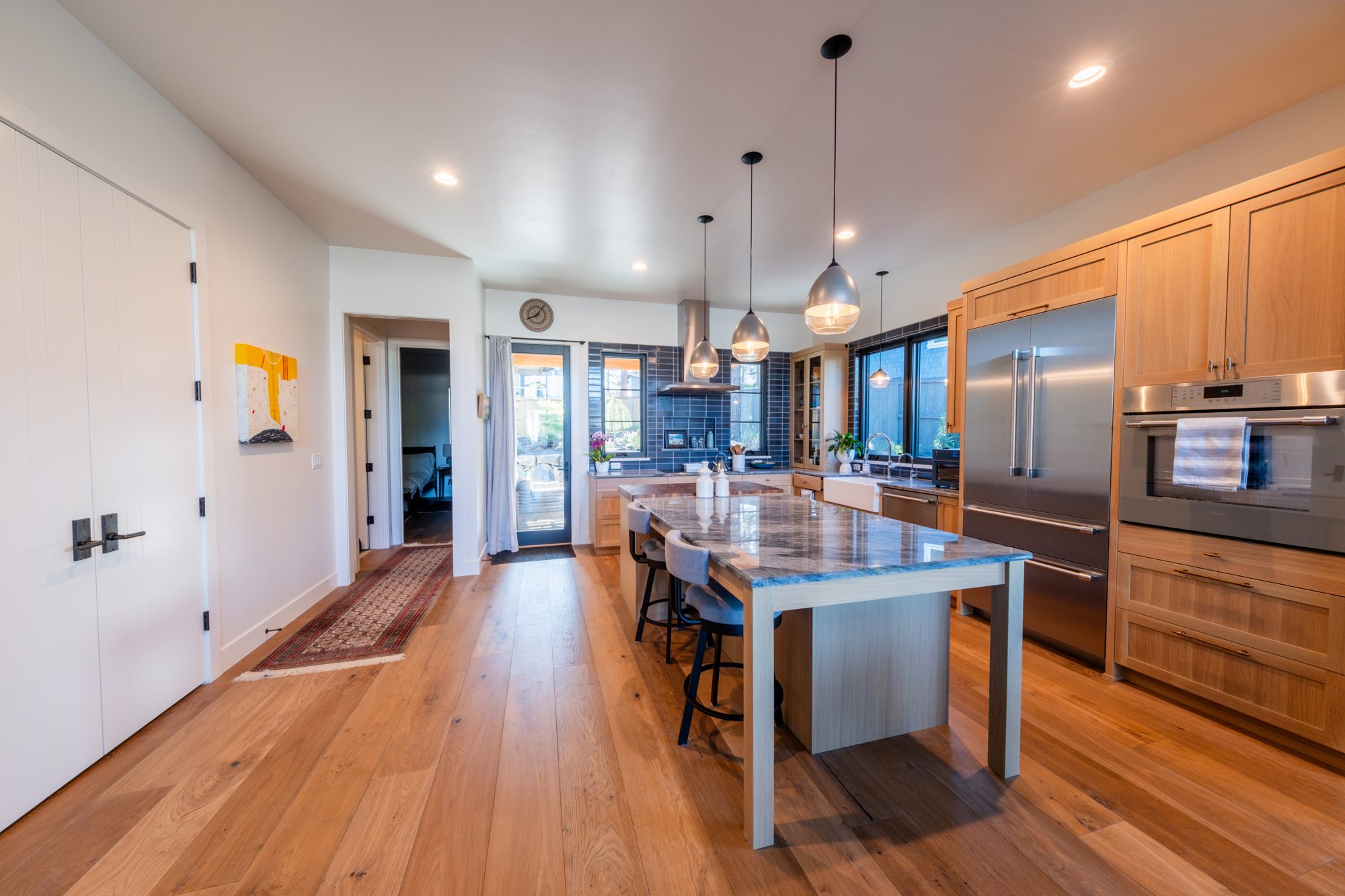 Dining area with designer pendant lights and hardwood floors