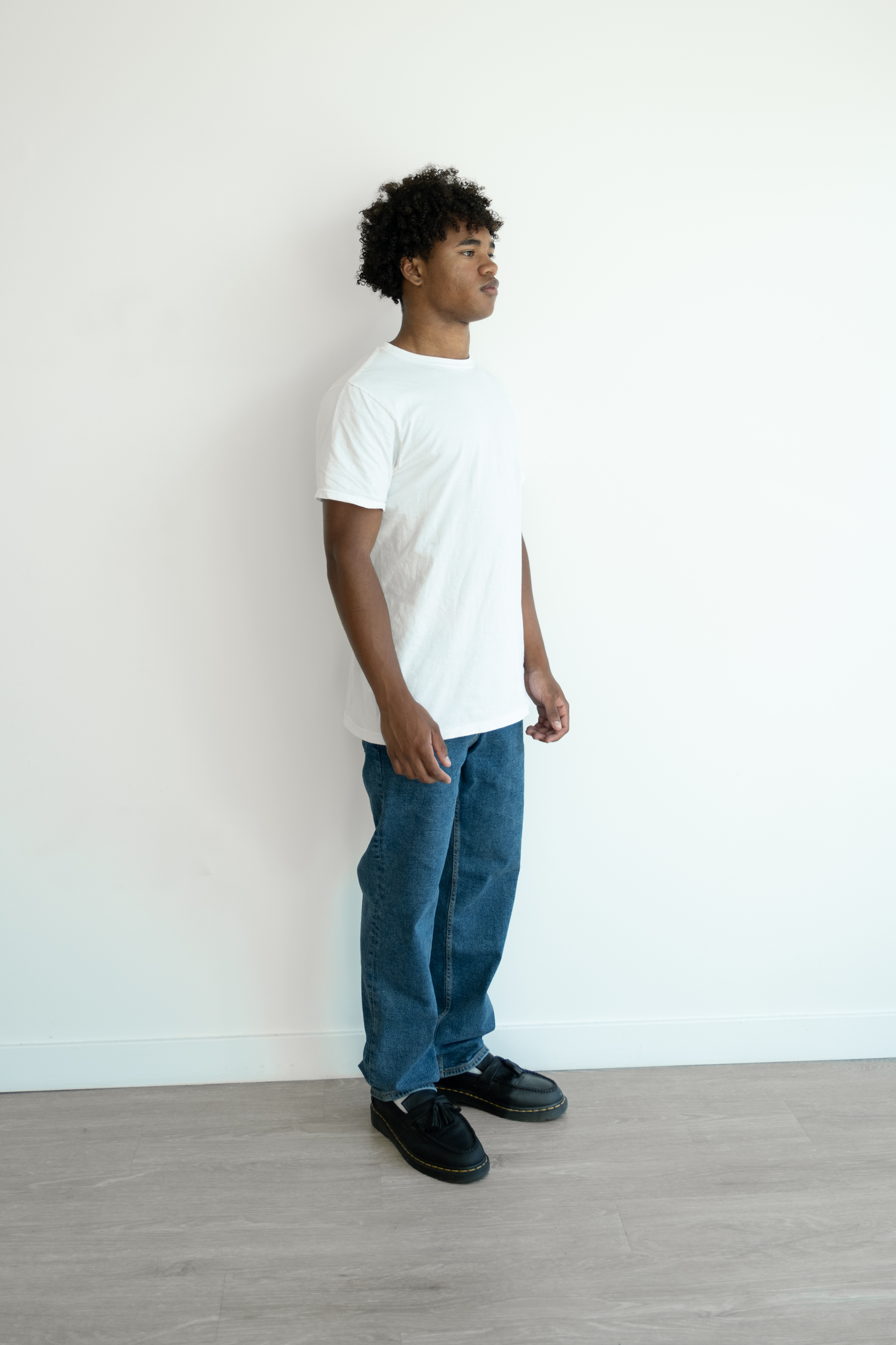 Smiling front-facing portrait in a black T-shirt against a plain white background.