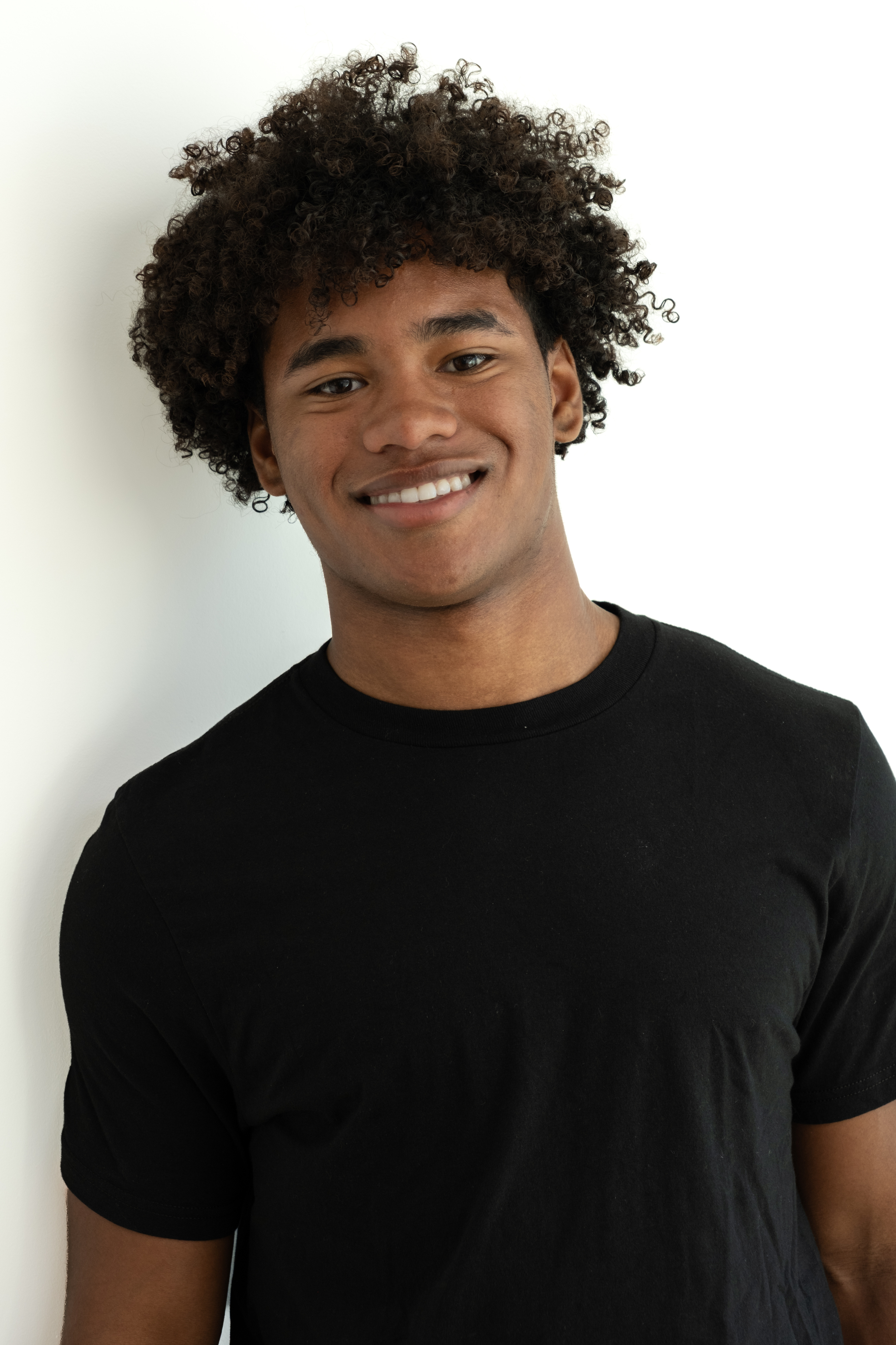 Rear full-length modeling digital in a white T-shirt and jeans against a plain white background.