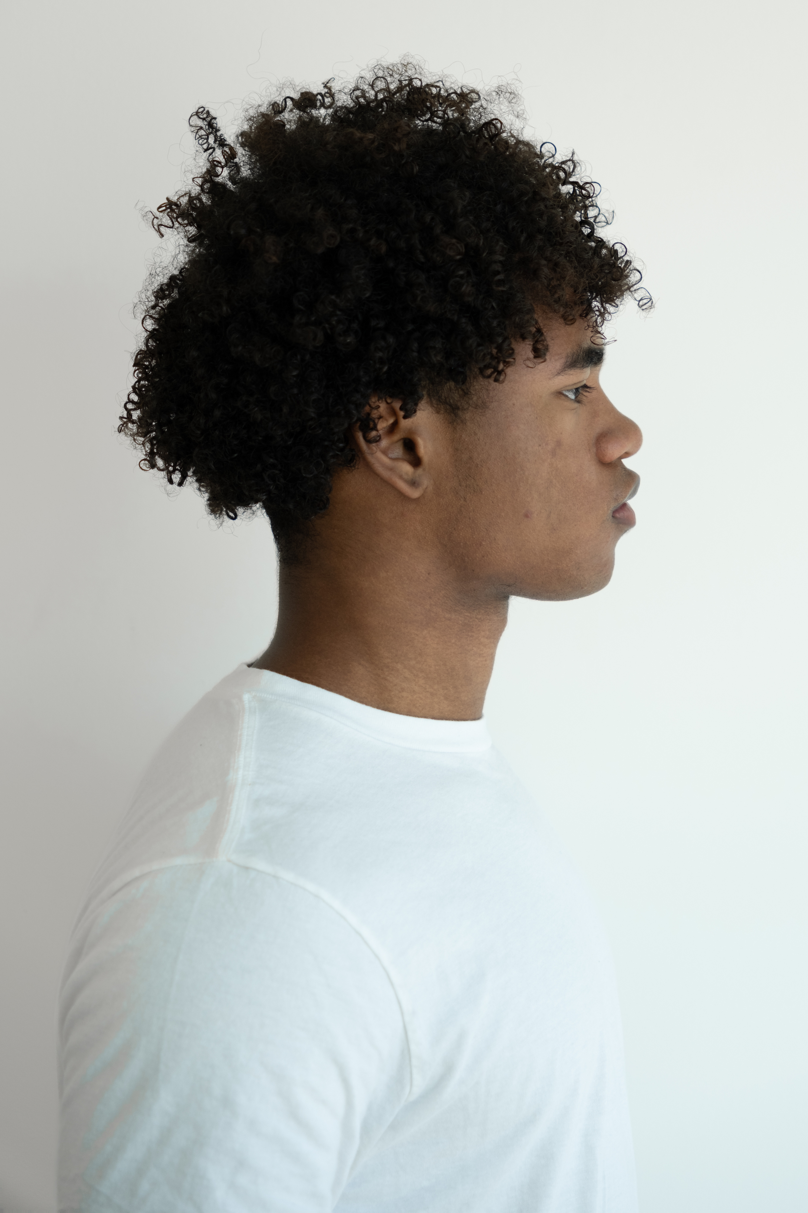 Front-facing waist-up modeling digital in a white T-shirt against a plain white background.