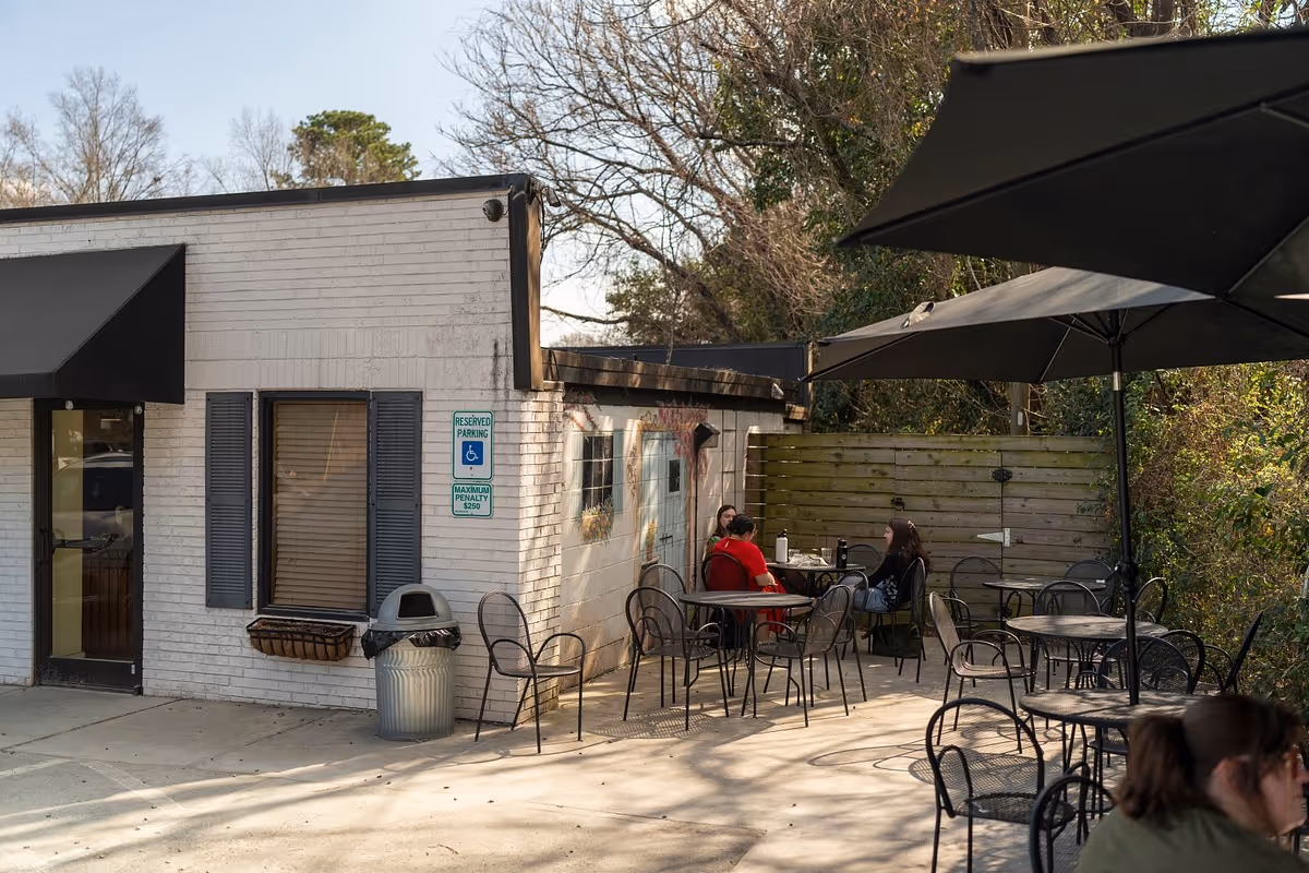 Outdoor seating area and storefront of Villani’s Bakery.
