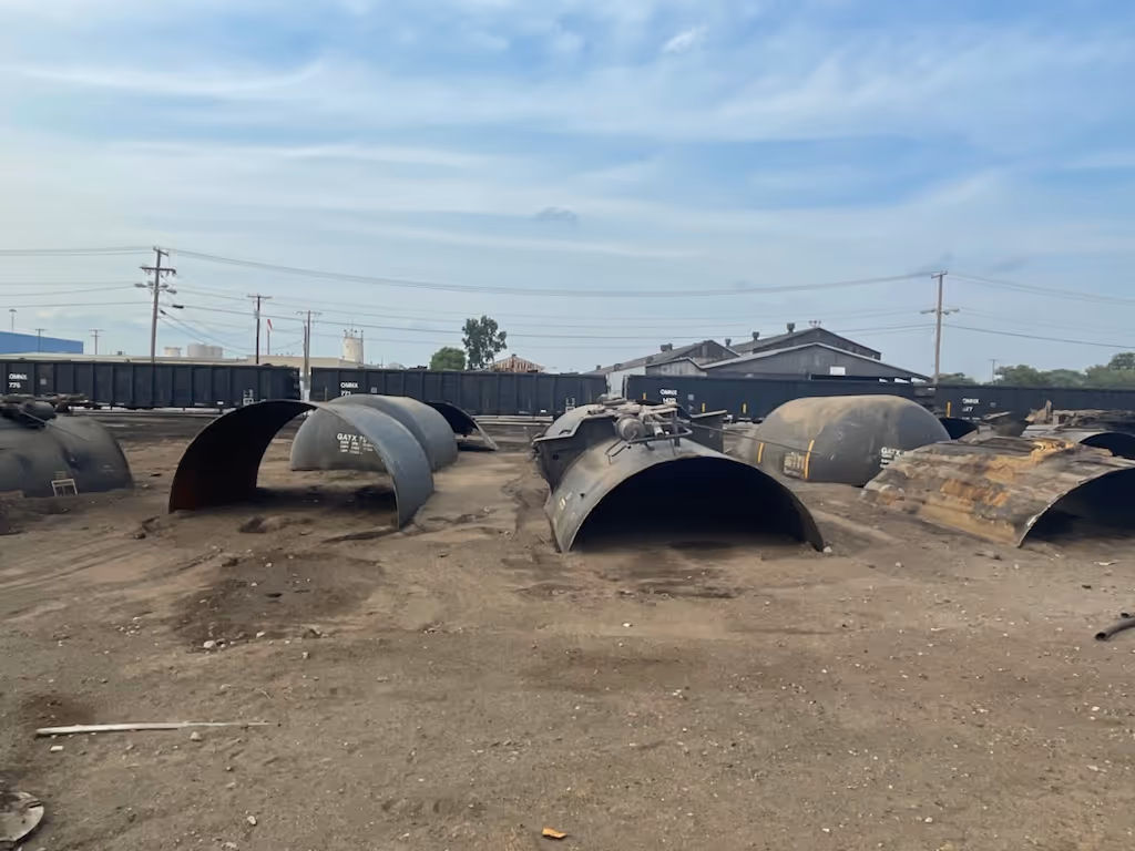A collection of metal tanks piled high, highlighting their metallic surfaces and robust construction.