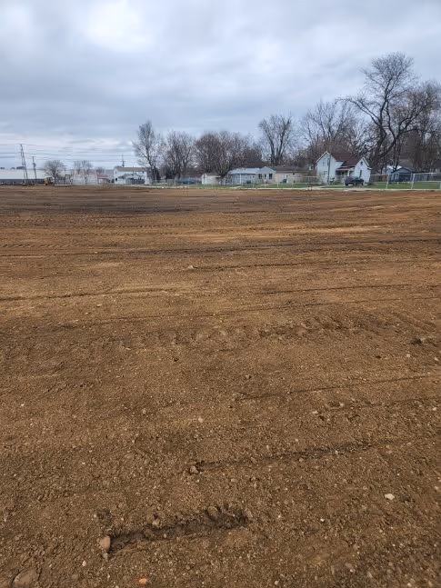 A cleaned up, flat, empty dirt area ready for construction.