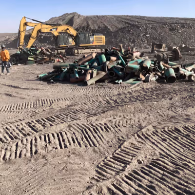 Scraps of metal being removed by machinery. 