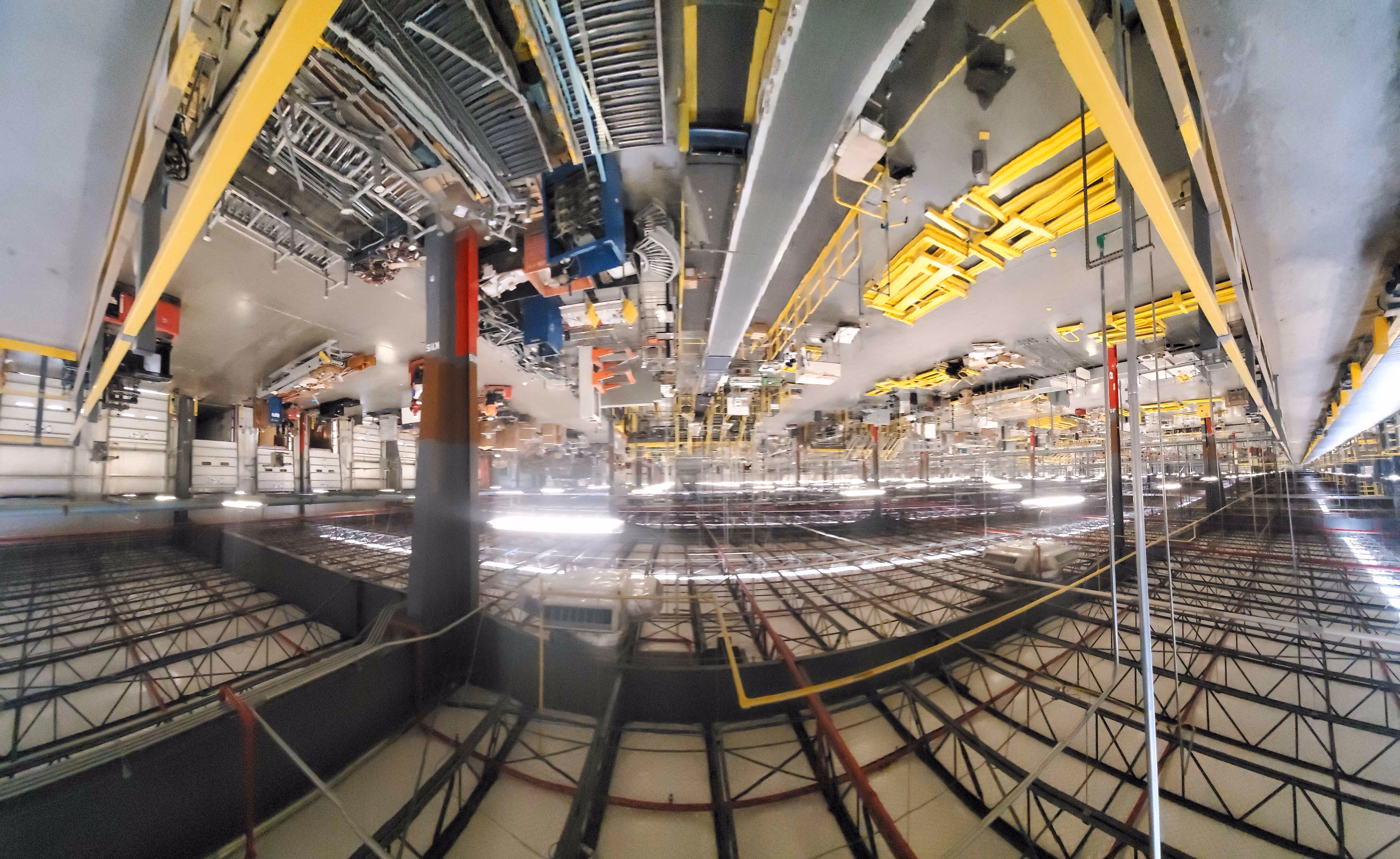 A factory scene featuring a camera positioned centrally within the industrial setting.