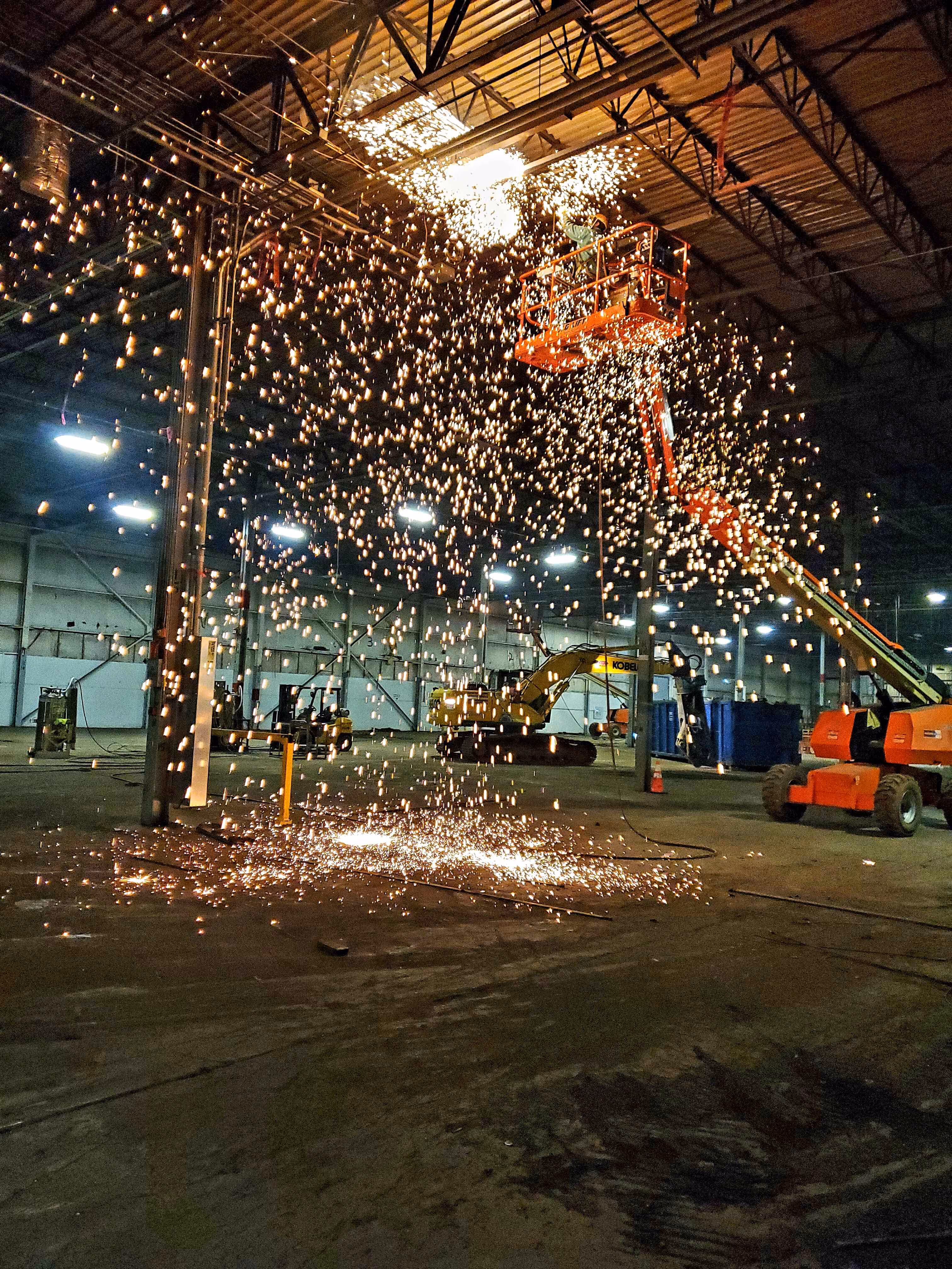 Nighttime view of partially deconstructed industrial site