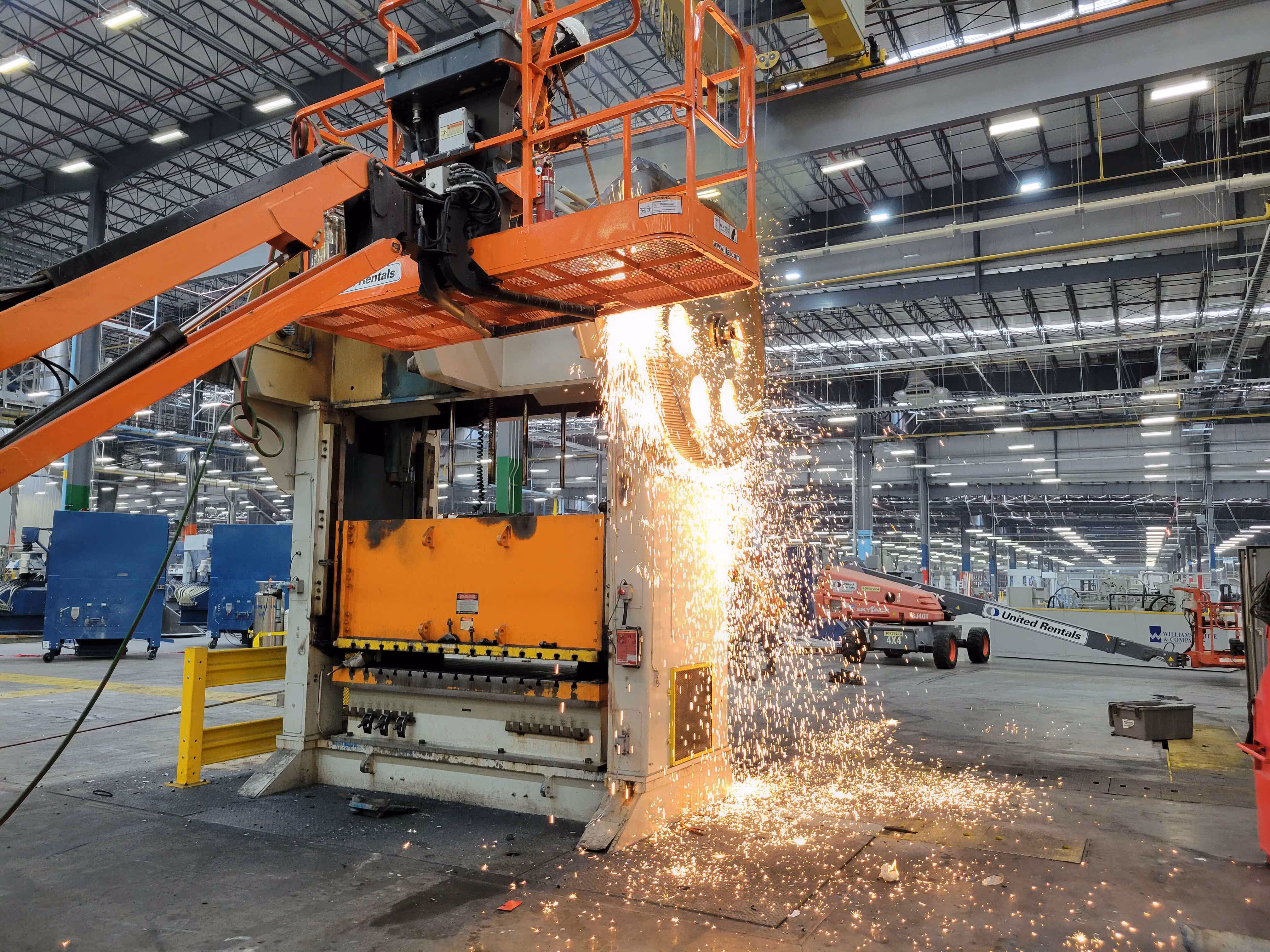 Torch cutting operation with sparks during machinery teardown