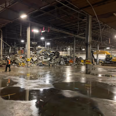 Interior demolition in progress under nighttime lighting