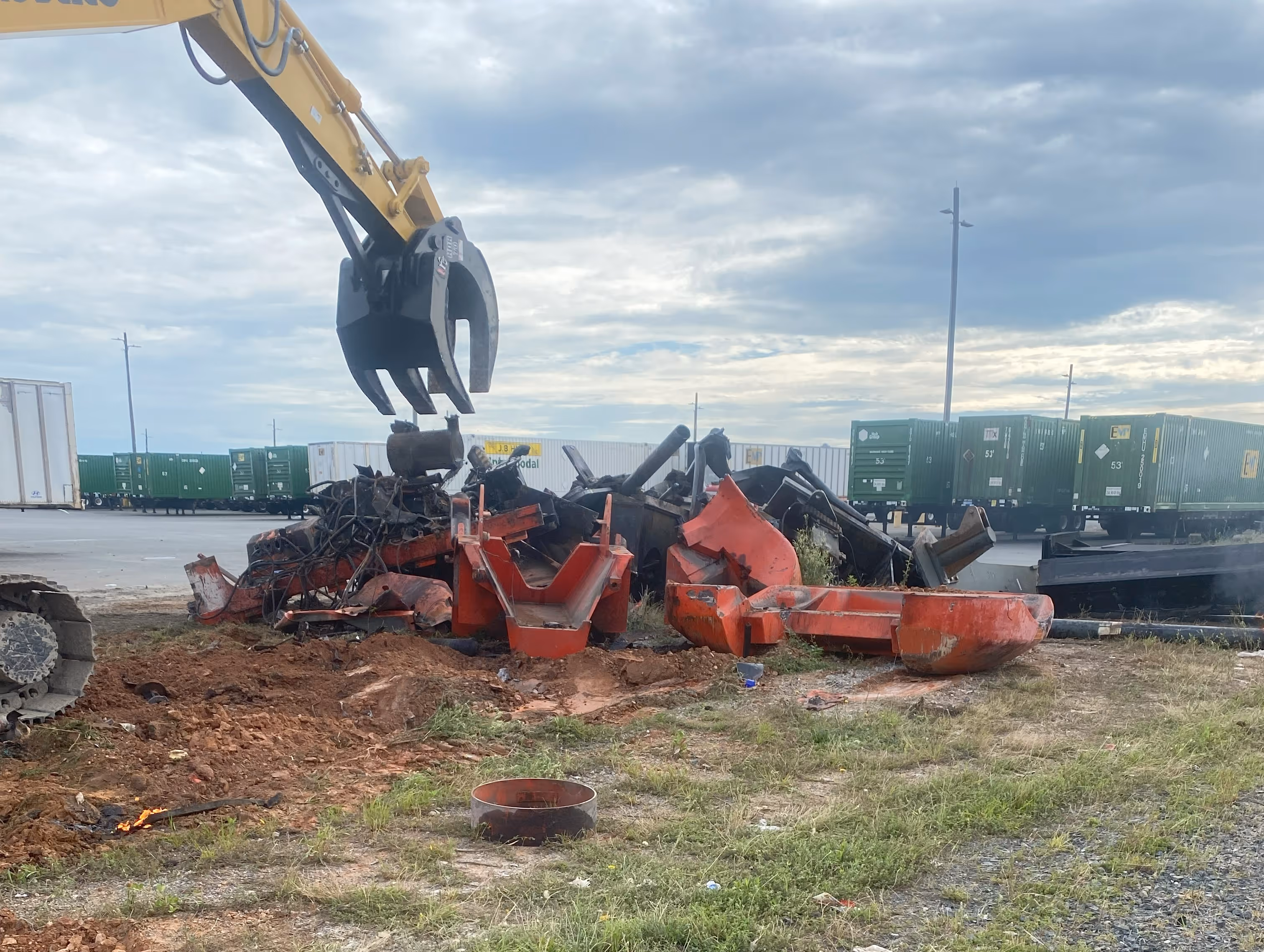 Shear equipment cutting scrap metal on active worksite