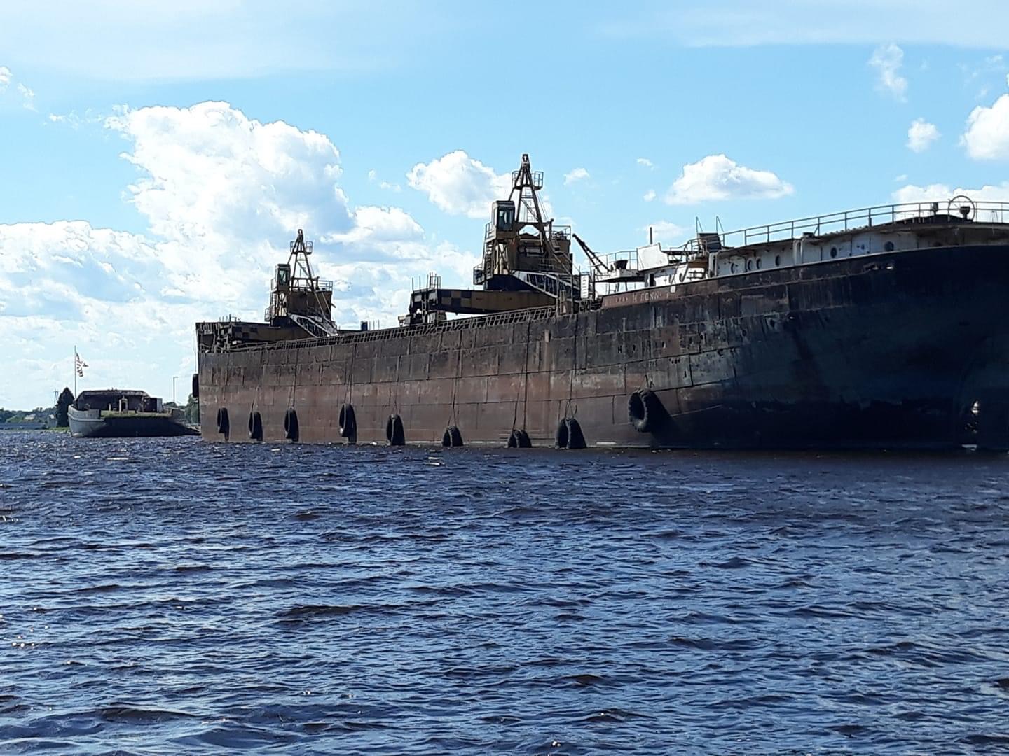 Marine decommissioning project featuring a retired military ship at port

