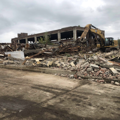 Completed structural teardown of an industrial facility with debris awaiting removal