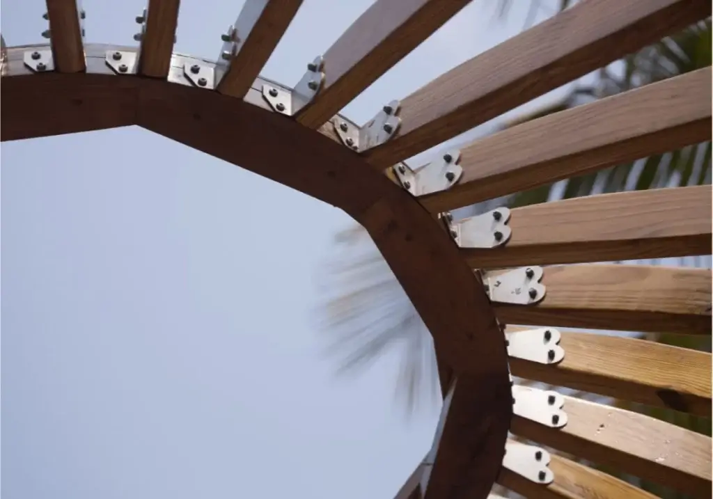 Close-up of a yurt skylight structure showcasing wooden beams and metal fittings